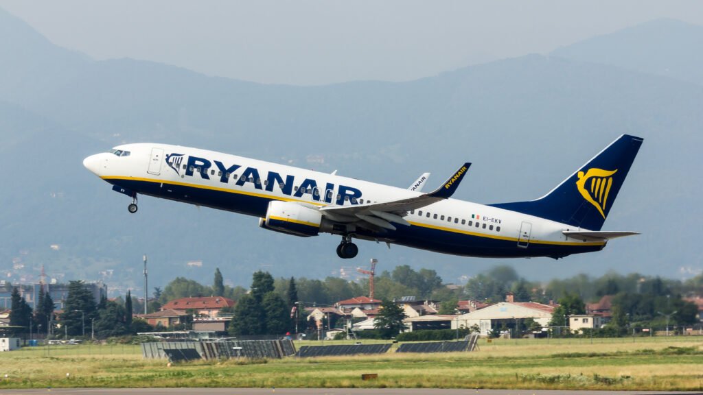 Kalamata, Greece: A Ryanair Boeing 737 aircraft operating as Flight FR6080 from London Stansted to Kalamata International Airport in Greece sustained significant damage after its right wingtip struck a ground barrier while taxiing post-landing on June 18, 2025. The incident occurred shortly after a routine landing and resulted in no injuries to passengers or crew. Incident Overview According to preliminary reports from Greek aviation authorities, the aircraft had completed its scheduled landing and was navigating the taxiway toward its designated gate when the outer portion of the right wing impacted a red-and-white painted airport fence. The collision caused visible structural damage to the wingtip. Emergency services were immediately deployed to assess the aircraft and ensure the safety of all on board. All 189 passengers were safely deplaned without any reported injuries. Eyewitness accounts from passengers described a loud noise followed by a jolt during the taxi, which raised initial concerns of a possible mechanical or navigational error. Aircraft Status and Response The Boeing 737 was grounded following the incident to allow for technical inspections and safety assessments. Ryanair’s engineering team, in coordination with Greek airport authorities, initiated a detailed evaluation of the damage. The aircraft was subsequently declared unfit for immediate return to service and will remain under maintenance until all repairs and inspections are completed in accordance with safety protocols. In a statement issued by Ryanair, the airline confirmed the incident and assured that full cooperation is being extended to regulatory bodies conducting the investigation. The airline also arranged alternate transport and support for affected passengers. Investigation and Safety Measures Greece’s Civil Aviation Authority (HCAA) has launched an investigation to determine the circumstances leading to the collision. Key areas under examination include the accuracy of taxiway markings, ground crew instructions, airport infrastructure layout, and the possibility of human error in aircraft maneuvering or ground vehicle placement. Preliminary findings indicate that the airport’s high summer traffic volumes may have contributed to congested conditions on the tarmac. Aviation safety analysts have also noted the increasing strain on regional airports such as Kalamata, which serve a growing number of seasonal flights across Southern Europe. The HCAA has confirmed that findings from the ongoing inquiry will be used to strengthen ground safety measures and prevent recurrence of similar incidents. Background Ground collisions involving aircraft remain relatively rare, especially during taxiing operations. However, such events can cause substantial damage and operational delays. The Kalamata incident comes just days after a fatal aviation accident in Ahmedabad, India, prompting wider discussions on ground safety practices and the need for infrastructure upgrades at smaller international airports. The Ryanair aircraft involved in the incident was a Boeing 737-800, a widely used narrow-body jet known for short- to medium-haul operations across Europe and beyond. The flight had departed London Stansted earlier that morning and landed on schedule in Kalamata before the collision occurred. Conclusion No injuries were reported as a result of the taxiway collision at Kalamata International Airport. Ryanair and Greek authorities continue to investigate the incident thoroughly, focusing on technical, operational, and environmental factors. The incident has reignited industry discussions on the importance of robust ground safety infrastructure and the growing demands placed on seasonal travel hubs across Europe. Further updates will be issued by the HCAA as the investigation progresses.