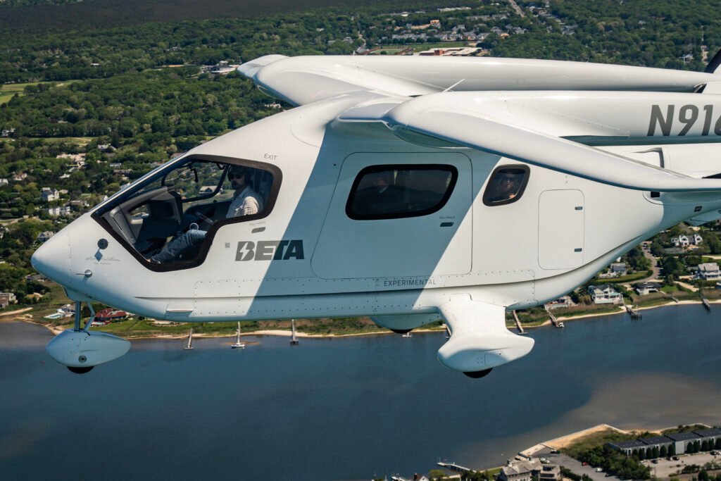 New York, United States: Beta Technologies has achieved a major milestone in electric aviation with the successful passenger flight of its all-electric aircraft, the Alia CX300, to New York’s John F. Kennedy International Airport. The flight marked the first time a fully electric aircraft carrying passengers entered controlled Class B airspace and landed at one of the busiest international airports in the United States. The aircraft departed from East Hampton Airport and completed the journey to JFK covering a distance of approximately 130 kilometers. The flight lasted around 35 minutes and was completed with a total energy cost of under $8, demonstrating the substantial cost-saving potential of electric propulsion compared to conventional fuel-based aircraft. The five occupants on board including four passengers and a pilot, reported a smooth and quiet experience, with noise levels significantly lower than traditional turbine aircraft. The flight proceeded under Visual Flight Rules and received full coordination from JFK’s tower and the New York Port Authority. FAA-Certified The Alia CX300 is a conventional takeoff and landing (CTOL) electric aircraft with a range of up to 250 nautical miles on a single charge. It received airworthiness certification from the U.S. Federal Aviation Administration, affirming its readiness for deployment in cargo, passenger, and special mission roles. The aircraft is part of Beta’s broader plan to offer electric solutions that cater to regional travel and logistics, particularly short-haul routes underserved by major airlines. With its proven operational capability and certification in place, the CX300 is being evaluated by multiple agencies, including the U.S. Air Force and Army, for defense and emergency response operations. Infrastructure and Commercial Expansion Beta Technologies is also investing heavily in the supporting infrastructure necessary to enable widespread electric flight. The company has established 46 electric aircraft charging stations across the U.S., with dozens more in development. These stations are strategically located at airports and logistics hubs to facilitate cross-country operations. Beta does not intend to operate its own fleet of aircraft. Instead, the company aims to sell the aircraft and associated charging infrastructure to customers in both civil and government sectors. Key commercial partners include UPS, Bristow Group, Metro Aviation, and Air New Zealand. In addition to the CX300, Beta is developing the Alia A250, a vertical take-off and landing (VTOL) version for urban and remote operations. Both aircraft share common airframes and power systems, which streamlines maintenance and pilot training requirements. Global Demonstrations and Future Outlook Following its high-profile arrival at JFK, Beta Technologies has expanded its demonstration campaign internationally. The company has conducted aircraft showings and test flights in Ireland and has scheduled further demonstrations in Norway. These efforts aim to showcase the feasibility of electric aircraft in diverse climates and regulatory environments. Domestically, the CX300 completed a six-week, 22-state tour to validate its operational capabilities, including successful landings at busy airports under Instrument Flight Rules (IFR). Beta Technologies has raised over $1 billion in investment funding to support production, certification, and commercialization. The company’s long-term vision includes integrating electric aircraft into public and private transportation networks, particularly for roles where noise, emissions, and operating costs are key concerns.