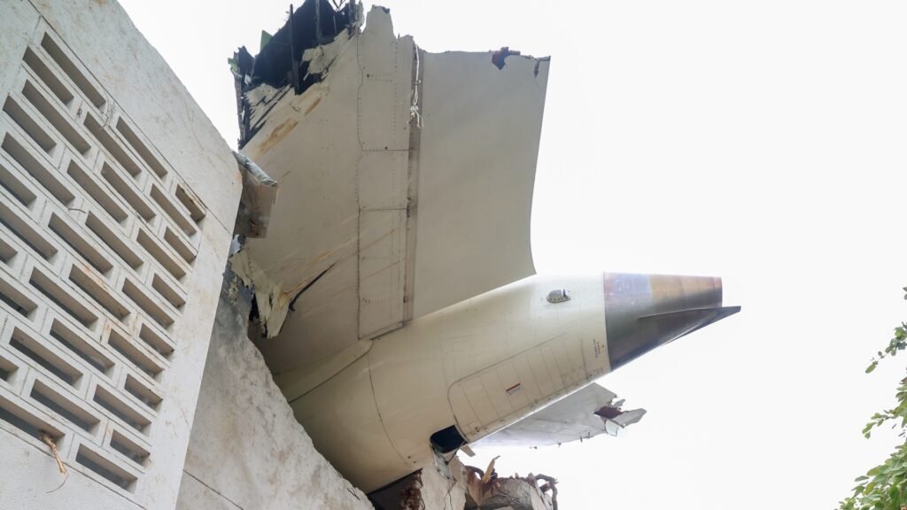 Ahmedabad, India: The Aircraft Accident Investigation Bureau (AAIB) has released the preliminary report into the crash of Air India’s Boeing 787-8 Dreamliner, registration VT-ANB, which occurred on 12 June 2025 shortly after takeoff from Ahmedabad’s Sardar Vallabhbhai Patel International Airport. The scheduled flight, operating as AI171, was bound for London Gatwick Airport with 230 passengers, 10 cabin crew, and 2 flight crew on board. All 241 persons on board perished in the accident. Additionally, 19 fatalities were reported on the ground.
Aircraft and Crew Information
The aircraft involved was a Boeing 787-8 with serial number 36279, manufactured in 2013, and operated by Air India. Both engines were General Electric GEnx-1B series units, installed in March and May 2025 respectively. The aircraft had a valid Certificate of Airworthiness and had undergone its last Airworthiness Review on 22 May 2025.
The Pilot-in-Command held an ATPL with over 15,638 hours of total flying experience, including 8,596 hours on type. The First Officer held a CPL with 3,403 hours of total flying experience, of which 1,128 hours were on type. Both pilots were based in Mumbai, had arrived in Ahmedabad the previous day, and had met required rest periods. The First Officer was the Pilot Flying for the accident flight.
Sequence of Events
On 12 June 2025, VT-ANB had earlier operated AI423 from Delhi and landed at Ahmedabad at 05:47 UTC. A post-flight defect regarding “STAB POS XDCR” was logged and addressed by on-duty maintenance personnel before the aircraft was released for its next flight.
Flight AI171 was scheduled for departure at 07:40 UTC. The aircraft pushed back from Bay 34 at 07:48 UTC, taxied to Runway 23, and received takeoff clearance at 08:07:33 UTC. The aircraft began its takeoff roll at 08:07:37 UTC.
According to data recovered from the Enhanced Airborne Flight Recorder (EAFR), the aircraft reached V1 at 08:08:33 UTC and rotation speed (Vr) at 08:08:35 UTC. It lifted off at 08:08:39 UTC and reached a maximum recorded indicated airspeed of 180 knots at 08:08:42 UTC.
At that moment, both engine fuel control switches, first for Engine 1 and then for Engine 2, with a one-second interval transitioned from the “RUN” to the “CUTOFF” position. The data indicated an immediate decrease in N1 and N2 engine speeds, consistent with fuel supply being cut off.
Cockpit voice recordings captured a pilot questioning the action, with one asking, “Why did you cut off?” and the other responding that he had not. No further verbal conflict or distress was recorded before the power loss.
Power Loss and Emergency Response
The sudden loss of thrust from both engines triggered the deployment of the Ram Air Turbine (RAT), visible on CCTV footage from the airport. The RAT began supplying hydraulic power by 08:08:47 UTC, confirming the engines were no longer providing power.
At 08:08:52 UTC, the Engine 1 fuel control switch was moved back to “RUN,” followed by Engine 2 at 08:08:56 UTC. The Auxiliary Power Unit (APU) inlet door also began to open at this time, indicating an automatic start sequence. Both engines attempted relight: Engine 1 showed signs of core recovery, while Engine 2 relit but could not stabilize its core speed.
At 08:09:05 UTC, a MAYDAY call was transmitted by one of the pilots. No further communication was received. The aircraft lost altitude rapidly and crashed into the BJ Medical College hostel complex approximately 0.9 nautical miles from the end of Runway 23.
The impact caused destruction of five buildings and extensive fire damage. All occupants of the aircraft were fatally injured. According to the report, the Emergency Locator Transmitter (ELT) was not activated during the sequence.
Recovery and Wreckage
The wreckage was spread across an area of approximately 1000 feet by 400 feet. The vertical stabilizer, main landing gear, fuselage components, both engines, and nose gear were found at various distances from the initial impact point. The thrust levers were discovered near the idle position, though flight data indicated they were forward (takeoff thrust) until impact. The fuel control switches were found in the “RUN” position post-crash.
The forward EAFR was successfully recovered and downloaded using equipment supplied by the U.S. National Transportation Safety Board (NTSB). It contained approximately 49 hours of flight data and two hours of audio, including the accident flight. The aft EAFR was too severely damaged to retrieve data.
Ongoing Investigation
The investigation team comprises AAIB India officers, subject matter experts, and international participants from NTSB (USA), Boeing, General Electric, the FAA, and authorities representing nations whose citizens were onboard. As of the preliminary report, there are no recommendations issued to operators or manufacturers of the B787-8 aircraft or GEnx-1B engines.
Fuel samples tested from the bowsers and tanks used to refuel the aircraft were found satisfactory. Additional trace samples collected from the APU and refuel/jettison systems are being sent for further testing. Statements from witnesses and the sole surviving passenger have been recorded.
Post-mortem analyses are underway to determine any relevant aeromedical findings. The AAIB emphasized that the investigation remains ongoing, and all evidence, including maintenance records, crew history, and system components, will continue to be evaluated.