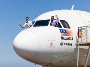 Kuala Lumpur, Malaysia: Capital A, the parent company of AirAsia, has announced the signing of a Memorandum of Understanding (MoU) with Airbus for the purchase of 50 A321XLR aircraft with the option to convert an additional 20 aircraft, bringing the total potential order to 70 aircraft. The agreement was signed during the 2025 Farnborough International Airshow, and marks a key milestone in AirAsia’s strategy to expand its low-cost, long-haul network. Aircraft Capabilities & Strategic Role The Airbus A321XLR (Extra Long Range) is designed to fly up to 8,700 km, enabling airlines to operate longer routes previously not viable with narrow-body aircraft. The introduction of these aircraft will allow AirAsia to open new direct long-haul routes, particularly between Asia, the Middle East, and secondary cities in Europe and North America. According to AirAsia, the A321XLR is a crucial component of its plan to offer cost-effective international connectivity with lower fuel consumption and improved environmental performance compared to widebody aircraft. Long-Haul Expansion Through New Hubs In line with the order, Capital A has also outlined a strategy to establish intermediate hubs in the Middle East, including locations such as Ras Al Khaimah (UAE) and Bahrain. These hubs are expected to serve as connection points for one-stop low-cost flights from Asia to destinations like London Gatwick, Cologne, and Manchester, and potentially cities in the United States. The goal is to replicate AirAsia’s successful point-to-point low-cost model on longer-haul sectors using the fuel-efficient A321XLR. The airline has stated that this expansion is aimed at addressing rising demand for affordable international travel while keeping operational costs competitive. Capital A Financial Restructuring and Integration Plans This announcement comes amid Capital A's broader restructuring initiative. The company is currently merging its short-haul airline business (AirAsia Malaysia) with AirAsia X, its medium-to-long-haul affiliate. This move will unify operations under a single AirAsia brand, streamlining its business model and improving operational efficiency. Capital A has further confirmed plans to exit its PN17 classification, a designation under Bursa Malaysia for financially distressed companies within 2025. The company also plans to issue its first corporate bond by October 2025, signalling investor confidence in its financial turnaround. Group CEO Tony Fernandes said the order aligns with Capital A’s vision to transform AirAsia into a global aviation brand that can compete on ultra-long-haul, cost-efficient routes, while continuing to serve its core ASEAN and Asian markets. Recent Route Developments As part of its regional growth, AirAsia X recently launched direct services to Karachi, Pakistan, achieving an inbound load factor of 95% and 80% outbound on its initial flights. The airline described this as a positive response from the South Asian market and plans to increase frequency depending on demand. In a separate update, AirAsia MOVE (formerly AirAsia Super App) introduced several tech enhancements, including biometric login, dynamic pricing bundles, and promotional campaigns under the tagline "Travel More for Less" across the Thai and ASEAN markets.