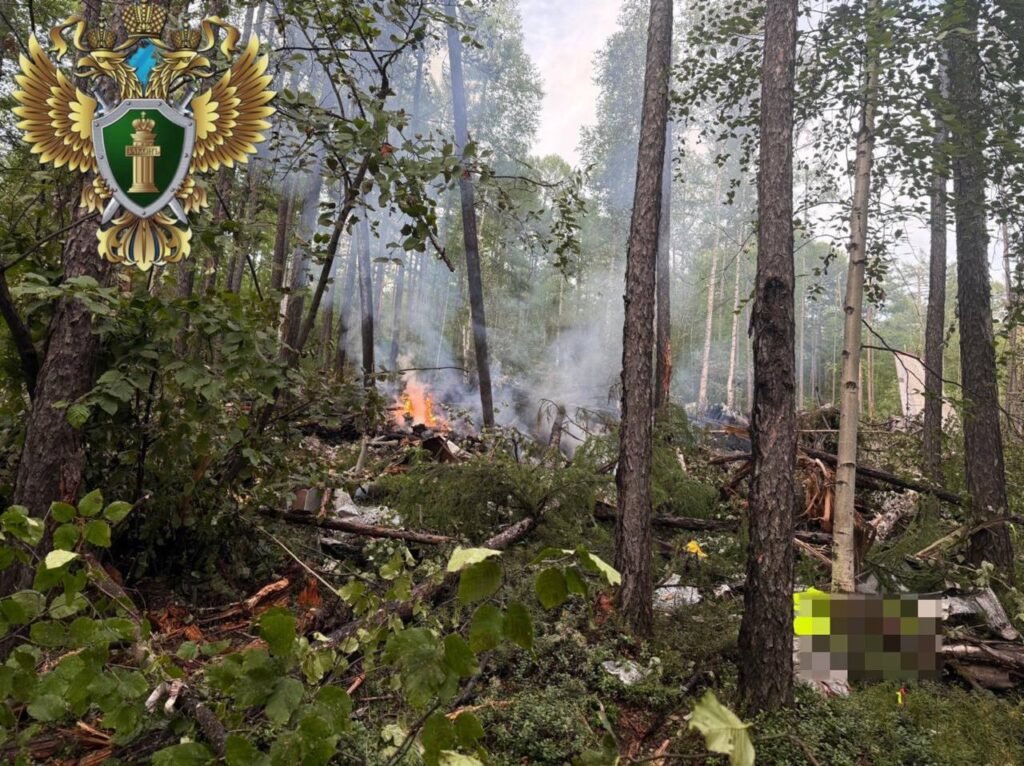 Tynda, Russia: A passenger aircraft operated by Angara Airlines crashed during its final approach to Tynda Airport in Russia’s Amur region on Wednesday, killing all 48 people on board. The crash occurred amid poor weather conditions and has prompted an official investigation by multiple federal and regional agencies. Aircraft Disappeared from Radar During Second Approach According to a statement from Rosaviatsiya, Russia’s Federal Air Transport Agency, the Antonov An‑24 aircraft was conducting a scheduled domestic flight from Blagoveshchensk to Tynda when it vanished from radar during a second landing attempt at approximately 10:30 a.m. local time. No distress call was issued by the flight crew prior to disappearance. The aircraft was located approximately 15 kilometers south of Tynda Airport, in heavily wooded terrain. Aerial reconnaissance by a Mi-8 helicopter from the Russian Emergencies Ministry visually confirmed the wreckage and noted that the fuselage was engulfed in flames at the time of discovery. Rescue teams were dispatched to the crash site by ground due to smoke and poor visibility preventing helicopter landings. No Survivors; Emergency Response Mobilized The Amur Regional Governor, Vasily Orlov, confirmed through an official statement that all 48 occupants (42 passengers and 6 crew members) perished in the accident. Among the deceased were five children. The Russian Emergencies Ministry deployed over 149 personnel and 21 units of equipment to the scene. The search and recovery operations have been hampered by steep terrain, dense forest cover, and lack of direct road access to the crash site. Authorities reported the fire had been extinguished by the time rescue teams reached the fuselage. Governor Orlov announced three days of official mourning in the Amur region beginning July 25. He also stated that psychological support services and family coordination centers have been established for the victims’ relatives. Criminal Investigation Launched The Investigative Committee of the Russian Federation has opened a criminal case under Article 263 of the Criminal Code, which addresses violations of transportation safety rules that result in fatalities. In a statement, Committee spokesperson Svetlana Petrenko confirmed that forensic experts, flight safety inspectors, and federal investigators have been dispatched to collect evidence from the site. The Far Eastern Transport Prosecutor’s Office is overseeing compliance with aviation safety protocols and maintenance documentation related to the flight and the airline. A joint technical commission has been formed to inspect aircraft logs, air traffic communication records, and crew qualifications. Aircraft Details and Maintenance Records The aircraft involved in the crash was a twin-engine Antonov An‑24, manufactured in 1976. Though several decades old, it was confirmed by Rosaviatsiya and Angara Airlines that the aircraft had passed its most recent technical inspection and was deemed airworthy. However, public records indicate that the aircraft had been involved in at least four minor incidents since 2018, including engine-related technical alerts. Investigators have not yet commented on whether previous mechanical issues may be linked to the crash. Russian President Vladimir Putin was briefed immediately following the incident. Kremlin spokesperson Dmitry Peskov stated that President Putin expressed condolences to the families of the victims and called for a comprehensive federal-level investigation. Prime Minister Mikhail Mishustin ordered the formation of a high-level commission to oversee the investigation and response. The commission will coordinate between federal aviation bodies, law enforcement, and the airline. The Prime Minister also instructed regional administrators to facilitate financial compensation and logistical support for next of kin. Preliminary Findings and Weather Conditions Although the final cause remains under investigation, initial assessments by emergency services and reported by TASS, Russia’s state news agency, suggest that crew error during landing in low-visibility conditions may have contributed to the crash. Visibility in the Tynda area was reported to be severely reduced due to fog and overcast conditions at the time of the attempted landing. Flight data recorders (black boxes) are being retrieved and will be analyzed by the Interstate Aviation Committee (IAC). No timeline has been issued for the preliminary report.