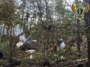 Tynda, Russia: A passenger aircraft operated by Angara Airlines crashed during its final approach to Tynda Airport in Russia’s Amur region on Wednesday, killing all 48 people on board. The crash occurred amid poor weather conditions and has prompted an official investigation by multiple federal and regional agencies. Aircraft Disappeared from Radar During Second Approach According to a statement from Rosaviatsiya, Russia’s Federal Air Transport Agency, the Antonov An‑24 aircraft was conducting a scheduled domestic flight from Blagoveshchensk to Tynda when it vanished from radar during a second landing attempt at approximately 10:30 a.m. local time. No distress call was issued by the flight crew prior to disappearance. The aircraft was located approximately 15 kilometers south of Tynda Airport, in heavily wooded terrain. Aerial reconnaissance by a Mi-8 helicopter from the Russian Emergencies Ministry visually confirmed the wreckage and noted that the fuselage was engulfed in flames at the time of discovery. Rescue teams were dispatched to the crash site by ground due to smoke and poor visibility preventing helicopter landings. No Survivors; Emergency Response Mobilized The Amur Regional Governor, Vasily Orlov, confirmed through an official statement that all 48 occupants (42 passengers and 6 crew members) perished in the accident. Among the deceased were five children. The Russian Emergencies Ministry deployed over 149 personnel and 21 units of equipment to the scene. The search and recovery operations have been hampered by steep terrain, dense forest cover, and lack of direct road access to the crash site. Authorities reported the fire had been extinguished by the time rescue teams reached the fuselage. Governor Orlov announced three days of official mourning in the Amur region beginning July 25. He also stated that psychological support services and family coordination centers have been established for the victims’ relatives. Criminal Investigation Launched The Investigative Committee of the Russian Federation has opened a criminal case under Article 263 of the Criminal Code, which addresses violations of transportation safety rules that result in fatalities. In a statement, Committee spokesperson Svetlana Petrenko confirmed that forensic experts, flight safety inspectors, and federal investigators have been dispatched to collect evidence from the site. The Far Eastern Transport Prosecutor’s Office is overseeing compliance with aviation safety protocols and maintenance documentation related to the flight and the airline. A joint technical commission has been formed to inspect aircraft logs, air traffic communication records, and crew qualifications. Aircraft Details and Maintenance Records The aircraft involved in the crash was a twin-engine Antonov An‑24, manufactured in 1976. Though several decades old, it was confirmed by Rosaviatsiya and Angara Airlines that the aircraft had passed its most recent technical inspection and was deemed airworthy. However, public records indicate that the aircraft had been involved in at least four minor incidents since 2018, including engine-related technical alerts. Investigators have not yet commented on whether previous mechanical issues may be linked to the crash. Russian President Vladimir Putin was briefed immediately following the incident. Kremlin spokesperson Dmitry Peskov stated that President Putin expressed condolences to the families of the victims and called for a comprehensive federal-level investigation. Prime Minister Mikhail Mishustin ordered the formation of a high-level commission to oversee the investigation and response. The commission will coordinate between federal aviation bodies, law enforcement, and the airline. The Prime Minister also instructed regional administrators to facilitate financial compensation and logistical support for next of kin. Preliminary Findings and Weather Conditions Although the final cause remains under investigation, initial assessments by emergency services and reported by TASS, Russia’s state news agency, suggest that crew error during landing in low-visibility conditions may have contributed to the crash. Visibility in the Tynda area was reported to be severely reduced due to fog and overcast conditions at the time of the attempted landing. Flight data recorders (black boxes) are being retrieved and will be analyzed by the Interstate Aviation Committee (IAC). No timeline has been issued for the preliminary report.