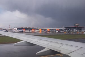 United States: Air travel across the United States experienced major disruption on Monday as severe weather systems swept across multiple states, grounding flights and straining airline operations. According to the latest data from tracking services and airport authorities, over 5,490 flights were delayed and 865 flights canceled as of mid-day, affecting both domestic and international operations. Airports Most Severely Affected The weather-related disruption has impacted some of the country’s busiest aviation hubs. Dallas–Fort Worth International Airport (DFW) recorded the highest number of delays and cancellations, with 648 delays and over 315 cancellations reported. In the Midwest, Chicago O’Hare International Airport (ORD) reported over 417 delays and more than 50 cancellations. The Northeast corridor, a critical region for airline operations, was also significantly affected. Boston Logan International Airport (BOS) saw more than 340 delays, while New York-area airports experienced mounting cancellations and extended ground delays due to active thunderstorms and air traffic management restrictions. In the South, Hartsfield–Jackson Atlanta International Airport (ATL) logged over 450 delays, making it one of the hardest-hit airports in the Southeast. Additional delays were reported at Philadelphia International Airport (PHL), where airlines struggled with storm-related ground stoppages and equipment slowdowns. Airlines Respond to Operational Challenges Major U.S. carriers including Delta Air Lines, American Airlines, United Airlines, JetBlue, and Spirit Airlines have been forced to either cancel or significantly delay flights across their domestic networks. Several airlines activated contingency plans, reassigning crews and equipment to minimize disruption to operations. Airlines have issued advisories for passengers traveling through impacted airports, urging them to check their flight status before leaving for the airport and allowing additional time for check-in and boarding. Many have also offered travel waivers, allowing rebooking without penalty for flights scheduled between July 14 and July 16. FAA Implements Weather-Related Traffic Flow Measures The Federal Aviation Administration (FAA) confirmed that weather-related traffic management initiatives were in place at multiple locations, including Newark Liberty International (EWR), John F. Kennedy International (JFK), and LaGuardia Airport (LGA). These include ground delay programs and flow restrictions to safely manage the volume of aircraft during active thunderstorms and low-visibility conditions. In addition, ground stops were temporarily imposed in parts of Florida, including Orlando, Fort Lauderdale, and Miami, as the storm system extended into the Southeast. Summer Travel Season Compounded by Weather The timing of the disruption comes during one of the busiest travel periods of the year. The summer season has already posed challenges for air traffic control and airport operations, with record passenger volumes, tight crew scheduling, and ongoing staffing pressures. According to data from the U.S. Department of Transportation, travel volumes in July 2025 are trending above pre-pandemic levels, making the impact of operational disruptions more severe for both airlines and travelers. Flight Disruption Likely to Continue Meteorologists have forecast continued storm activity along the East Coast and Midwest through Tuesday, increasing the likelihood of further disruptions. Airlines are urging passengers with flexible travel plans to consider alternative dates. Airport authorities across affected cities have also issued travel advisories and are working with airlines and ground handling teams to manage crowd control and terminal congestion. Passengers are advised to stay updated through airline apps, official airport websites, and the FAA’s real-time flight status portal.