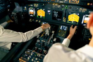 Bengaluru, India: A Commercial Pilot scheduled to operate Air India flight AI 2414 from Bengaluru to Delhi collapsed inside the cockpit just before takeoff on Friday morning, triggering a delay and raising fresh concerns about pilot health and fatigue within the aviation sector. Pilot Collapses During Pre-Flight Checks The incident occurred at Kempegowda International Airport while the flight crew was completing mandatory pre-flight procedures. According to sources, the pilot fell ill while signing the aircraft’s technical log, a standard requirement before pushback. Airport medical teams and ground staff responded promptly, and the pilot was transported to a nearby hospital, where he is reported to be in stable condition. Air India confirmed the incident stating, “The operating pilot on AI 2414 (Bengaluru–Delhi sector) reported unwell during pre-flight checks and was immediately attended to. A standby pilot was arranged, and the flight departed with a revised schedule. The pilot is under medical care and is stable. All relevant safety procedures were followed.” Flight Departed After Crew Replacement Air India quickly activated its standby crew protocol. The replacement pilot assumed command of the flight after mandatory clearance checks. Flight AI 2414, originally scheduled to depart at 3:05 AM IST, eventually took off at 4:36 AM IST and landed in Delhi at approximately 7:30 AM. Passengers were kept informed during the delay, and no further disruptions were reported. This medical emergency comes just weeks after another concerning incident involving pilot health. On April 9, 2025, a First Officer with Air India Express suffered a fatal cardiac arrest shortly after operating a domestic flight from Srinagar to Delhi. According to reports, the young pilot, identified as Captain Armaan, vomited inside the cockpit shortly after landing. He exited the aircraft and collapsed outside the galley area. Emergency services rushed him to the hospital, but he was declared dead on arrival. The back-to-back nature of these incidents has led to growing concern about health risks among commercial pilots, especially in the wake of demanding flight schedules and overnight duties. The Directorate General of Civil Aviation (DGCA) has been actively monitoring airline crew rostering practices, particularly at Air India. Earlier this year, the regulator identified multiple violations in flight and duty time limitations (FDTL) and rest requirements. Following an internal audit, Air India removed several officials involved in crew scheduling. The DGCA is also in the process of implementing revised FDTL norms effective July 2025. Key changes include: Increasing weekly rest time from 36 to 48 hours Limiting the number of night landings to two per week Capping consecutive night duties to three Mandatory off-duty period for red-eye (overnight) flights These changes aim to reduce fatigue-related risks and improve operational safety across Indian carriers.
