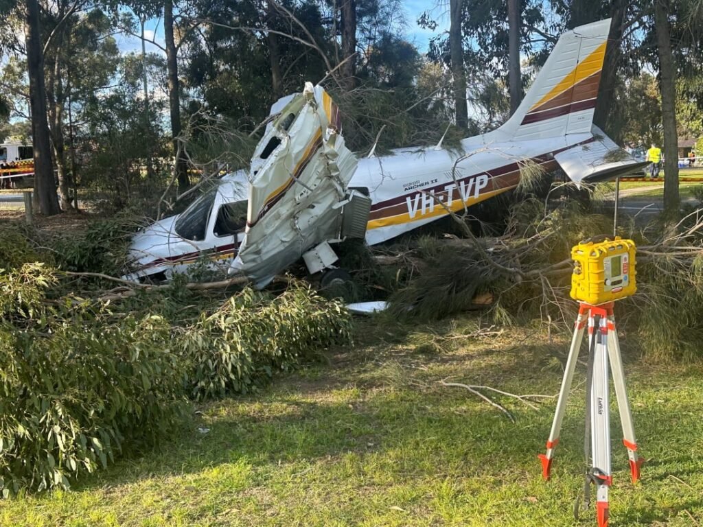 Sydney, Australia: A training flight ended in a dramatic emergency landing on Sunday afternoon when a light aircraft carrying a flight instructor and a student pilot crash-landed on the Mona Vale Golf Course in Sydney’s Northern Beaches. Both men survived with minor injuries, according to emergency officials. The aircraft, identified as a Piper Cherokee, went down shortly after 2:00 p.m. during a scheduled training flight. Witnesses told ABC News Australia that the plane lost height quickly before skidding across the golf course, tearing off its landing gear and damaging one wing before coming to rest on the green. Paramedics confirmed that both occupants, an instructor and his student, each believed to be in their 50s, managed to exit the wreckage without assistance. One suffered minor facial cuts while the other was treated for shock. Both were transported to Royal North Shore Hospital, where they remain in stable condition. Nearby golfers rushed to the scene moments after the crash, providing initial assistance before emergency services arrived. Eyewitnesses described the landing as “hair-raising” but credited the instructor’s quick decision-making for avoiding a far more serious tragedy. The Piper Cherokee had departed Camden Airport and was heading south towards Wollongong when engine trouble was suspected mid-flight. Investigators believe the pilot attempted to divert but was forced to make an emergency landing, selecting the golf course as the safest available option. Video footage shared by multiple outlets,shows the aircraft gliding at low altitude before impacting the turf and skidding across the fairway. The landing gear collapsed on impact, and debris scattered across the course. The Australian Transport Safety Bureau (ATSB) confirmed it had been notified and is gathering preliminary evidence. However, it is not yet clear whether a full on-site investigation will be launched.
