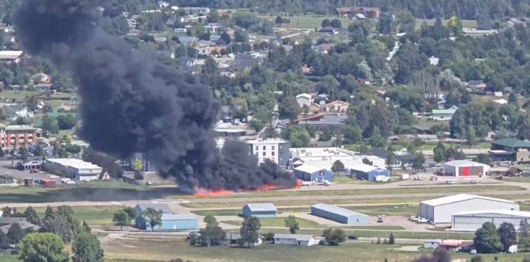 Montana, United States: A small private aircraft crash-landed into multiple parked planes at Kalispell City Airport on Monday afternoon, sparking an intense fire but resulting in no serious injuries, authorities confirmed. The incident involved a 2011-built Socata TBM 700 turboprop, registered to Meter Sky LLC of Pullman, Washington. According to the Kalispell Fire Department, the single-engine plane was carrying four people, the pilot and three passengers when it attempted to land at around 2:00 p.m. local time. Initial reports from Kalispell Fire Chief Dan Pearson indicate that the TBM 700 touched down normally but lost directional control during rollout. The aircraft veered off the runway and collided with several parked planes on the apron. The collision ruptured fuel lines, triggering a blaze that quickly spread to the nearby grassy area adjacent to the tarmac. All four occupants managed to evacuate the aircraft before flames engulfed it. Two people suffered minor injuries and received treatment on-site, while the other two were unhurt. No injuries were reported among ground personnel. Multiple firefighting units from Kalispell and surrounding districts responded within minutes. Eyewitnesses described the crash as sudden and violent. Mark Grant, manager of the Aero Inn located near the airport, recounted to AP NEWS the moment of impact: “It was like sticking your head inside a bass drum and someone hitting it with all their might. The sound rattled the windows.” Several onlookers captured videos that circulated widely on social media, showing thick columns of black smoke rising from the airfield as emergency crews rushed to the scene. The Federal Aviation Administration (FAA) confirmed it has opened a preliminary inquiry into the crash, while the National Transportation Safety Board (NTSB) will lead the formal investigation. The investigators will examine factors including runway surface conditions, aircraft mechanical integrity, and potential pilot error. The TBM 700’s flight data and cockpit voice recorders, though not required for all private planes, will be checked if installed. The NTSB’s initial report is expected within two weeks, but a final determination could take up to a year.