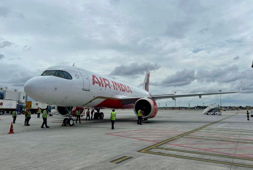 New Delhi, India: A Delhi-to-Indore Air India flight AI2913 made a precautionary return to Indira Gandhi International Airport shortly after takeoff on Sunday after the cockpit crew received a fire indication in the aircraft’s right engine. According to Hindustan Times, the pilots acted immediately, declared an emergency, and shut down the affected engine following standard safety protocols. They then requested priority landing clearance from Air Traffic Control and safely brought the aircraft back to Delhi, where fire and rescue teams were on standby as a precaution. Air India confirmed that all passengers and crew members disembarked safely. The airline arranged an alternate aircraft so passengers could continue their journey to Indore with minimal disruption. The affected aircraft has been grounded for a detailed engineering inspection to determine the cause of the fire indication. Air India also notified the Directorate General of Civil Aviation (DGCA), which is expected to review the incident as part of its routine safety oversight. The incident comes a month after an Air India Express flight bound to Doha from Calicut International Airport returned a couple of hours after take-off due to a technical fault.