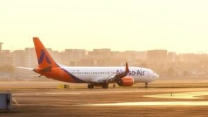 Varanasi, India: A scheduled Akasa Air flight QP 1424, from Varanasi to Bengaluru failed to depart at 7:55 PM on Thursday, leaving 143 passengers stranded overnight in Varanasi following a technical issue. The flight had already been boarded when the problem surfaced. The aircraft was being pushed back from the gate toward the runway when the pilot was alerted to a fault. As a precautionary measure, the pushback was halted and the aircraft returned to the apron for further inspection. The airline’s technical crew attempted repairs for approximately three hours, but the fault could not be fixed. By around 11:30 p.m., the airline announced that the service would not operate. Passengers waited for several hours at the airport before being informed of the cancellation. Subsequently, Akasa Air made arrangements to accommodate the affected passengers in nearby hotels for the night. An Akasa Air spokesperson said “Passengers who chose alternate flight options were provided airport transfers and refreshments. At Akasa Air, passenger safety and comfort are paramount, and we deeply regret the inconvenience caused.” Authorities and airline officials have yet to release a public statement explaining the precise nature of the technical fault. No further updates regarding compensation or rebooking timelines have been formally communicated.