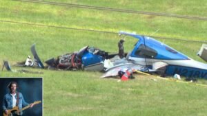 North Carolina, United States: A small private plane crashed in a field near Iotla Valley Elementary School in Macon County on Thursday afternoon, killing all three people on board. Authorities have confirmed that the deceased include award-winning Nashville songwriter Brett James, 57. The Cirrus SR22T aircraft (tail number N218VB) went down shortly after 3 p.m. local time on September 18, just west of the school grounds in Franklin. The aircraft is registered to James and had departed from John C. Tune Airport in Nashville, Tennessee, earlier that day, according to the Federal Aviation Administration (FAA). The Macon County Sheriff’s Office and local media reports confirmed the fatalities. Songwriter Brett James, whose career spanned more than two decades, was among those killed. He was known for penning hits including “Jesus, Take the Wheel” (Carrie Underwood) and “When the Sun Goes Down” (Kenny Chesney). James’s passing has sent shockwaves through the Nashville music community, where he was regarded as one of the most versatile and prolific writers of his generation. His songs, often blending country and pop influences, earned him Grammy Awards and recognition from both the Academy of Country Music and the Country Music Association. The identities of the two other victims have not yet been officially released. While the crash site was close to Iotla Valley Elementary School, officials confirmed that no students or staff were injured. The Macon County Sheriff’s Office emphasized that the wreckage was located in a field adjacent to the school and did not impact school property. Parents and staff were quickly notified, and emergency crews secured the area. The FAA and the National Transportation Safety Board (NTSB) have launched a joint investigation into the cause of the accident. The North Carolina Highway Patrol assisted local law enforcement in securing the crash site. The FAA is expected to release a preliminary accident report within the next few days, though full investigations can take months. Brett James’s career began as a recording artist before he transitioned to songwriting, where he built a reputation for crafting chart-topping hits across multiple genres. Beyond country music, he collaborated with artists in pop and rock, including Bon Jovi, Taylor Swift, and Kelly Clarkson. His songwriting not only brought him industry acclaim but also cemented his influence on Nashville’s modern sound. In addition to writing, James was active in mentoring young musicians and was deeply respected within Music Row’s creative community. According to the FAA, small private aircraft like the Cirrus SR22T are among the most commonly flown in the U.S., and while equipped with advanced safety features including parachute recovery systems accidents still occur.