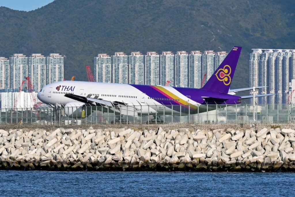 Bangkok, Thailand: Thai Airways International is preparing to retire its First Class service within the next two to three years, opting instead to invest in an upgraded Business Class as part of a sweeping fleet and product modernization plan. The national carrier’s Chief Executive Officer, Chai Eamsiri, confirmed the decision during a recent briefing, framing it as a move toward long-term efficiency and competitiveness. “We plan to eliminate First Class and replace it with enhanced Business Class cabins. It is part of our strategic plan to improve our product consistency and align with passenger demand,” he said. At present, Thai Airways operates a mixed product that includes Economy, Premium Economy, Business (“Royal Silk”), and First Class (“Royal First”) on select Boeing 777-300ER aircraft. The airline intends to streamline this into a three-class offering: Economy, Premium Economy, and an elevated Business Class. The airline will gradually refurbish its wide-body fleet, particularly the Boeing 777-300ERs, to remove First Class suites and replace them with a next-generation Business product. This new “Business Plus” concept is expected to include more spacious seating in the front row, enhanced privacy potentially with doors and upgraded amenities. While First Class is being phased out, Thai Airways aims to bridge the gap by enriching its Business Class service.The airline has already begun introducing premium amenities into Business, including caviar service on select routes. This aligns with a wider industry trend in which airlines consolidate luxury offerings into an expanded Business Class product rather than maintaining costly, limited-use First Class cabins. Passenger demand also played a decisive role.The modern Business Class products now rival traditional First Class in terms of comfort and privacy, making the higher-cost cabin less attractive and less financially sustainable for carriers. Thai Airways’ shift is also tied to its broader fleet renewal strategy. New aircraft on order, such as Boeing 787-9 Dreamliners, will be delivered without First Class cabins. The carrier is also retrofitting its existing fleet to ensure product consistency. Maintaining First Class across just a handful of aircraft and routes such as Bangkok to London and Tokyo has become impractical. Rationalizing the fleet is expected to lower operating costs and simplify scheduling.