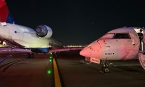 New York, United States: A low-speed collision between two Delta Connection regional jets disrupted operations at LaGuardia Airport on Wednesday night, injuring a flight attendant and damaging both aircraft. The incident occurred when Delta Connection Flight 5155, operated by Endeavor Air and scheduled to depart for Roanoke, Virginia, struck the nose of Delta Connection Flight 5047 arriving from Charlotte, North Carolina. The right wing of the departing CRJ-900 clipped the cockpit section of the arriving aircraft. The collision shattered cockpit windows and damaged the forward fuselage of the Charlotte flight. A cabin crew member on board sustained a knee injury and was taken to a local hospital. No passengers were hurt. The Port Authority of New York and New Jersey confirmed that airport operations continued without major disruption. The Endeavor flight 5155 was carrying 32 people including 28 passengers and 4 crewmembers whereas Endeavor flight 5047 was carrying 61 people in which 57 were passengers and 4 crewmembers, all passengers were safely deplaned and transported by bus to the terminal, where Delta arranged hotel accommodation, meals, and rebooking support. The NTSB has dispatched a team of ten investigators and recovered flight recorders from both aircraft for analysis. The FAA stated that Flight 5155 had been instructed to hold position before the collision, but the exact circumstances remain under investigation. The focus will include taxiway intersection layout, air traffic control instructions, and pilot decision-making. Flights resumed on schedule Thursday morning, with no further delays.
