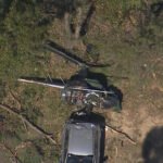 Sydney, Australia: A fatal helicopter crash occurred at Bankstown Airport in Sydney's south-west on Friday, when the helicopter Crashed into a car resulting in the death of a man and leaving a teenager in critical condition. At approximately 1:30 PM, emergency services responded to reports of a helicopter crash on Birch Street, near Bankstown Airport. Upon arrival, they found a man in his 50s deceased at the scene. A 19-year-old male, believed to be a student, sustained serious injuries. He was transported to Liverpool Hospital in critical condition. Witnesses reported hearing a loud noise and observing the helicopter struggling in the air before it crashed through multiple trees and landed on a parked car. One witness, who was in a nearby classroom, received a call from a friend who had heard the crash and rushed to the scene. They managed to pull the teenager from the wreckage, who was described as shaken but alive. The Australian Transport Safety Bureau (ATSB) is conducting a formal investigation into the cause of the crash. The incident occurred during a training flight, with the deceased man believed to be the instructor. The ATSB is expected to release a preliminary report within weeks, with a final investigation report to follow in the coming months.