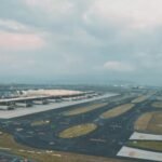 Mumbai, India: On October 8, 2025, the first phase of the Navi Mumbai International Airport (NMIA) was inaugurated, marking a significant milestone in India’s aviation sector. Built at a cost of around Rs 19,650 crore under a Public-Private Partnership (PPP) model by the Adani Group, the airport is expected to ease congestion at Mumbai’s Chhatrapati Shivaji Maharaj International Airport and enhance the city’s position as a global aviation hub. Phase 1 of NMIA features Terminal 1 and Runway 1, equipped with 10 bus gates and 29 aero bridges. The facility is designed to handle 20 million passengers annually, with plans to expand capacity to 90 million in future phases. Its lotus-inspired architecture includes 12 sculptural columns resembling petals and 17 mega columns supporting the roof, reflecting India’s cultural heritage. Situated in Ulwe, Navi Mumbai, about 37 kilometers from South Mumbai, NMIA is integrated with multimodal transport options, including metro, roadways, and public transport systems, ensuring seamless connectivity. The airport also hosts India’s largest aircraft maintenance, repair, and overhaul (MRO) facilities, positioning it as a major cargo and logistics hub. Prime Minister Narendra Modi attended the inauguration ceremony, alongside Maharashtra Chief Minister Devendra Fadnavis, Deputy Chief Ministers Eknath Shinde and Ajit Pawar, highlighting the national importance of the project. Chief Minister Fadnavis announced that the first ticket issued from the airport would bear the name of the late D.B. Patil, a prominent farmer leader and legislator. Commercial operations are scheduled to begin in December 2025. NMIA’s advanced facilities, strategic location, and integration with multimodal transport networks are set to transform Mumbai’s aviation landscape. In addition, the 'Mumbai One' app was launched to enhance urban mobility. The platform integrates services from 11 public transport operators across the Mumbai Metropolitan Region, allowing seamless travel on trains, metros, buses, monorails, and Navi Mumbai Municipal Transport (NMMT), which serves around 200,000 passengers daily.