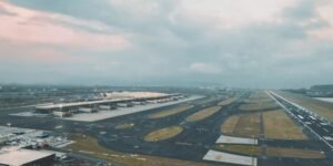 Mumbai, India: On October 8, 2025, the first phase of the Navi Mumbai International Airport (NMIA) was inaugurated, marking a significant milestone in India’s aviation sector. Built at a cost of around Rs 19,650 crore under a Public-Private Partnership (PPP) model by the Adani Group, the airport is expected to ease congestion at Mumbai’s Chhatrapati Shivaji Maharaj International Airport and enhance the city’s position as a global aviation hub. Phase 1 of NMIA features Terminal 1 and Runway 1, equipped with 10 bus gates and 29 aero bridges. The facility is designed to handle 20 million passengers annually, with plans to expand capacity to 90 million in future phases. Its lotus-inspired architecture includes 12 sculptural columns resembling petals and 17 mega columns supporting the roof, reflecting India’s cultural heritage. Situated in Ulwe, Navi Mumbai, about 37 kilometers from South Mumbai, NMIA is integrated with multimodal transport options, including metro, roadways, and public transport systems, ensuring seamless connectivity. The airport also hosts India’s largest aircraft maintenance, repair, and overhaul (MRO) facilities, positioning it as a major cargo and logistics hub. Prime Minister Narendra Modi attended the inauguration ceremony, alongside Maharashtra Chief Minister Devendra Fadnavis, Deputy Chief Ministers Eknath Shinde and Ajit Pawar, highlighting the national importance of the project. Chief Minister Fadnavis announced that the first ticket issued from the airport would bear the name of the late D.B. Patil, a prominent farmer leader and legislator. Commercial operations are scheduled to begin in December 2025. NMIA’s advanced facilities, strategic location, and integration with multimodal transport networks are set to transform Mumbai’s aviation landscape. In addition, the 'Mumbai One' app was launched to enhance urban mobility. The platform integrates services from 11 public transport operators across the Mumbai Metropolitan Region, allowing seamless travel on trains, metros, buses, monorails, and Navi Mumbai Municipal Transport (NMMT), which serves around 200,000 passengers daily.