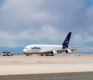 Berlin, Germany: Two of Europe’s leading carriers Lufthansa and Ryanair are scaling back their operations in Germany, citing rising aviation taxes, airport charges, and regulatory costs that have rendered several domestic and regional routes economically unviable. Budget carrier Ryanair has confirmed plans to cut approximately 800,000 seats across its German winter schedule, removing 24 routes and reducing flights at nine airports, including Berlin, Hamburg, and Memmingen. The airline attributed its decision to what it calls “excessive access costs” that continue to undermine the country’s competitiveness within Europe’s aviation landscape. “Germany has priced itself out of growth,” a Ryanair spokesperson said in a statement. “While other European markets have reduced aviation taxes to support recovery, Germany continues to impose high charges that discourage airlines from adding capacity.” Ryanair has reiterated that it will redirect aircraft and capacity to other European countries unless the German government acts to reduce its aviation levies and air traffic control fees. The carrier’s decision follows the closure of smaller German bases such as Dortmund, Dresden, and Leipzig, which remain excluded from the upcoming winter operations. National flag carrier Lufthansa is also taking significant measures to curb costs, planning to cut around 100 domestic flights per week this winter. The airline’s leadership has warned that high “location costs” including fuel surcharges, airport fees, and environmental levies are eroding profitability on short-haul routes. Lufthansa CEO Carsten Spohr has publicly voiced concerns over Germany’s aviation competitiveness, warning that continued cost escalation could force deeper reductions in the carrier’s domestic schedule by next summer. “Our cost base in Germany is among the highest in Europe. Without structural reforms, airlines will inevitably reconsider the scale of their operations here,” Spohr said. Lufthansa’s adjustments are part of a wider trend of airlines reassessing capacity deployment in high-cost markets, as European carriers continue to battle inflationary pressures and environmental surcharges. The dual retrenchment by Lufthansa and Ryanair has reignited debate over Germany’s aviation tax policy. Industry observers note that Berlin’s failure to deliver on its earlier pledge to lower aviation taxes has worsened the country’s cost environment. Germany’s aviation tax, introduced to curb emissions and raise revenue, remains among the highest in Europe. Analysts warn that these levies combined with rising fuel costs and environmental compliance expenses risk undermining the post-pandemic recovery of the country’s aviation sector. Ryanair’s capacity reduction alone accounts for nearly 10% of its total planned German seat supply this winter, a significant setback for airports already struggling with traffic stagnation.