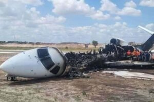 Kolwezi, Africa: The Democratic Republic of Congo’s Mines Minister, Louis Watum Kabamba, along with other passengers, survived a runway overrun and fire at Kolwezi Airport on Monday, officials confirmed. The chartered aircraft, an Embraer ERJ-145 operated by Airjet Angola (registration D2-AJB), was on a flight (MBC-100) from Lubumbashi to Kolwezi when it veered off runway 29 during landing and caught fire. According to the bureau of aircraft accident archives, both main landing gears were reportedly sheared off as the airplane came to a halt, and the tail section ignited. All 26 passengers and 3 crew evacuated; there are no reported fatalities or serious injuries. Initial reports suggest the aircraft touched down before a displaced threshold on runway 29, which was under maintenance. The Notam issued for Kolwezi Airport indicated that 1,000 metres of the runway were being resurfaced, reducing the effective landing distance. According to the Bureau of Aircraft Accidents Archives, this could have contributed to the gear collapse. Eyewitnesses and social media footage show thick smoke rising from the rear fuselage as passengers escaped, some via overwing exits. Isaac Nyembo, communications adviser to Minister Kabamba, said around 20 people were evacuated before the fire spread, though luggage was damaged. Concerns have also been raised over emergency response readiness at Kolwezi Airport. No fire trucks arrived for several minutes, despite the airport being categorized to require rapid rescue capability. Minister Kabamba and his delegation were heading to Kalondo, near Kolwezi, following a recent mining accident in which over 30 workers died in a bridge collapse. The delegation was expected to assess the damage, console affected families, and coordinate government support. An investigation has been launched by the DRC’s aviation authority (BPEA) into the cause of the runway excursion and fire. Kolwezi Airport, located in Lualaba Province, has a single asphalt runway (11/29), around 2,410 metres long. Aviation experts have pointed out that infrastructure challenges, such as runway maintenance, coupled with limited firefighting capacity, may pose ongoing safety risks.