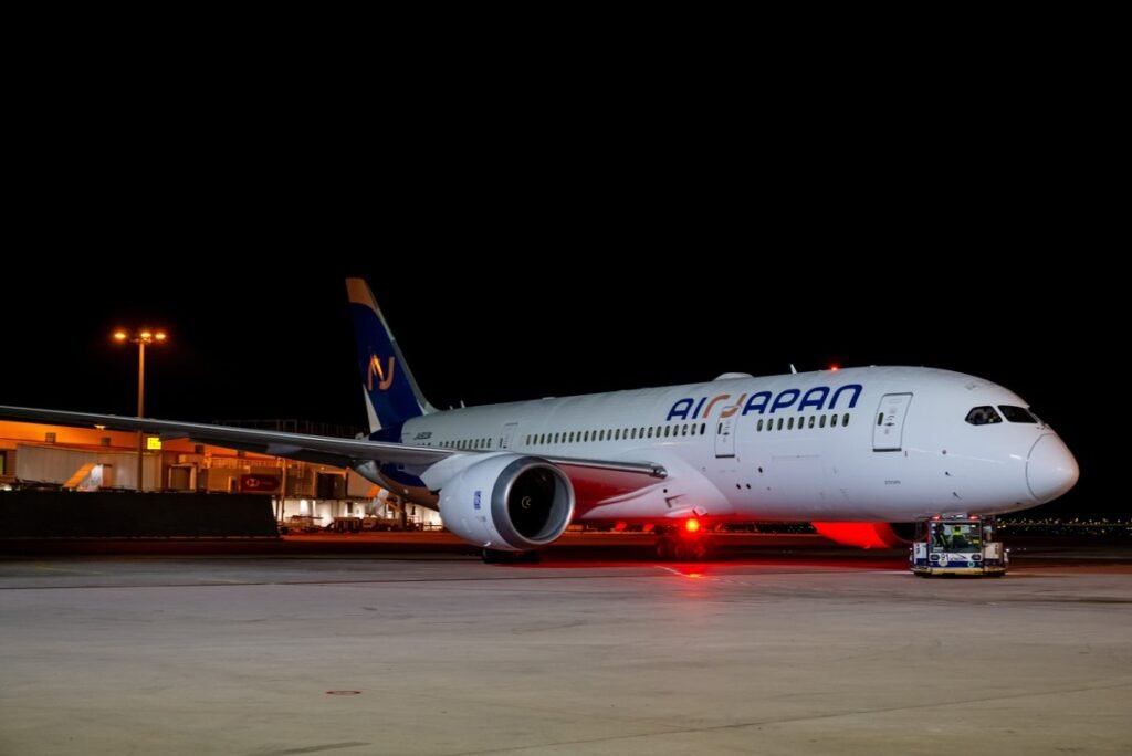 Tokyo, Japan: ANA Holdings has confirmed it will end all scheduled flight operations under the AirJapan (NQ) brand by March 2026, consolidating the hybrid subsidiary into the mainline All Nippon Airways (ANA) network. The company said the move is part of a broader effort to streamline its international operations following persistent supply chain disruptions and aircraft delivery delays. Under the plan, AirJapan will cease branded flights at the end of March 2026, though it will remain an independent Air Operator’s Certificate (AOC) within the group, operating flights on behalf of ANA. The transition effectively turns AirJapan into a capacity provider for its parent airline rather than a separate commercial brand. AirJapan had launched in February 2024 to capture inbound leisure traffic to Japan, offering a simplified cabin and unbundled pricing on medium-haul routes. Despite initial optimism, industry analysts noted that demand fluctuations and competition from established low-cost carriers in Southeast Asia made profitability challenging. AirJapan currently flies three international routes from Tokyo Narita to Bangkok Suvarnabhumi, Singapore Changi, and Seoul Incheon using two Boeing 787-8s and one 787-9. These services will continue until the end of March 2026, with the final scheduled flight from Singapore to Narita set for March 29, 2026. After the withdrawal of its standalone operations, AirJapan’s aircraft and crews will be fully integrated into ANA’s international division, maintaining service continuity under the ANA brand identity. The decision follows ongoing operational challenges affecting the Boeing 787 fleet across ANA Holdings, five of ANA’s 34 B787-8s and five of 43 B787-9s remain inactive due to supply chain issues and maintenance delays linked to engine and component shortages. These disruptions have constrained AirJapan’s growth plans, which initially targeted a five-aircraft fleet by late 2025. ANA Holdings also cited the prolonged impact of the Russian invasion of Ukraine, which forced route diversions and increased operational costs for Japan-Europe flights. ANA Group said the integration would “expand the ANA brand’s international business by leveraging AirJapan’s operational expertise and high service quality.” The carrier’s hybrid model positioned between ANA’s full-service offering and the low-cost Peach Aviation brand struggled to achieve sustainable margins in a competitive post-pandemic market. ANA executives acknowledged that maintaining a third brand had become less viable amid rising costs and limited aircraft availability.