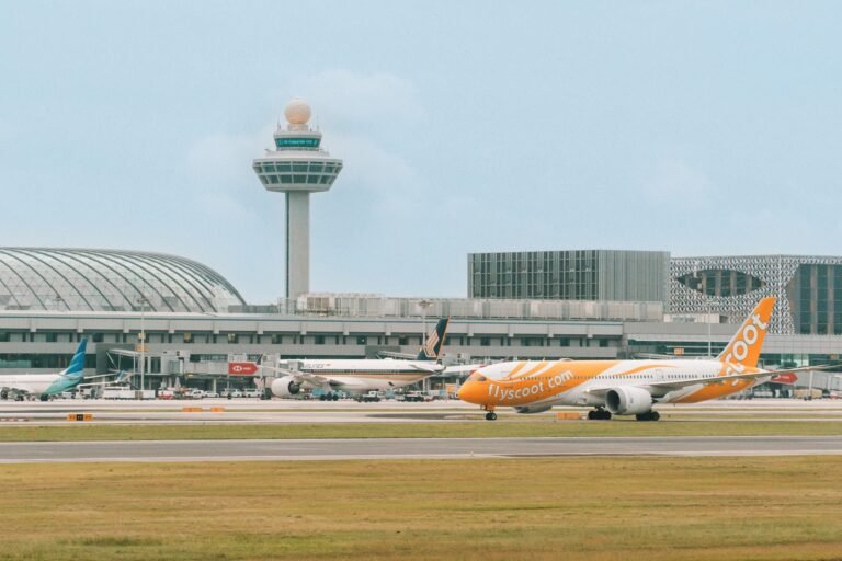 Singapore: Passengers flying out of Changi Airport and Seletar Airport will soon pay a new Sustainable Aviation Fuel (SAF) levy starting in 2026, as part of Singapore’s drive to reduce the aviation sector’s carbon emissions and support global decarbonisation goals. According to the Civil Aviation Authority of Singapore (CAAS), the levy will apply to tickets issued from April 1, 2026, for flights departing on or after October 1, 2026. The collected funds will be channelled into purchasing sustainable aviation fuel, helping airlines transition away from fossil-based jet fuel. Under the new system, passengers will pay different levy rates depending on destination zones and cabin classes: Band 1 – Southeast Asia: Economy S$1 | Premium S$4 Band 2 – Northeast Asia, South Asia, Australia & Papua New Guinea: Economy S$2.80 | Premium S$11.20 Band 3 – Africa, Europe, Middle East, Pacific Islands, Central & West Asia: Economy S$6.40 | Premium S$25.60 Band 4 – The Americas: Economy S$10.40 | Premium S$41.60 Transit passengers passing through Singapore will be exempt from the levy. The scheme will also cover cargo operators, business aviation, and general aviation flights, which will pay a SAF contribution based on aircraft weight or cargo load. CAAS stated that the initiative is a market-based mechanism designed to accelerate the uptake of SAF in a cost-effective and transparent manner. The authority said the levy would make the cost of cleaner fuel predictable for airlines and travellers while ensuring funds are ring-fenced for SAF purchases. “The SAF levy is a key part of Singapore’s decarbonisation framework for aviation. It enables us to make steady progress towards our targets while maintaining competitiveness as a global air hub,” CAAS said in a statement. Singapore’s aviation decarbonisation roadmap targets at least 1 % SAF usage by 2026, increasing to 3 %–5 % by 2030, depending on supply availability and cost developments. The levy rates could be adjusted in future as the SAF blend ratio rises. Globally, sustainable aviation fuel remains more expensive than conventional jet fuel typically costing two to five times more but is widely regarded as the most immediate tool to cut aviation’s carbon footprint. Singapore’s move follows similar measures adopted in the European Union and Japan, and could set a precedent for other Asian hubs exploring SAF mandates or incentives. The initiative complements broader efforts under the International Civil Aviation Organization’s (ICAO) CORSIA framework, which aims for net-zero carbon emissions from international aviation by 2050. By creating a structured and transparent levy system, Singapore aims to send a clear demand signal to fuel producers and investors, potentially attracting SAF production and supply-chain projects to the region.