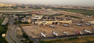 New Delhi, India: India’s aviation industry is bracing for a difficult FY2026, with ICRA estimating sector-wide losses to climb to Rs 95–105 billion, almost double the Rs 55 billion loss expected in FY2025. Softening passenger growth, upcoming fleet inductions and ongoing global and domestic disruptions are set to pressure financial performance. Even so, ICRA has maintained a stable outlook for the year, supported by steady travel demand, though influenced by cross-border tensions, accident-related caution and tariff-linked challenges on the commercial side. Domestic passenger traffic in October 2025 reached 142.8 lakh, up 4.5% from October 2024 and 12.9% higher than September 2025. Capacity deployment grew 1.7% year-on-year to 99,816 departures, with passenger load factor rising to 84.7%, compared with 82.4% a year earlier. For April–October 2025, domestic traffic stood at 944.5 lakh, a 1.6% year-on-year increase. ICRA expects full-year FY2026 domestic travel to grow 4–6%, reaching 172–176 million passengers. International traffic carried by Indian airlines rose 5.8% year-on-year in September 2025, touching 28.3 lakh, though sequentially down by 5.7%. In H1 FY2026, international traffic reached 175.6 lakh, marking 9.1% growth. ICRA projects further expansion of 13–15% in FY2026. Aviation turbine fuel (ATF) remains a key cost concern. ATF prices in November 2025 were 4.4% higher year-on-year and 0.8% higher month-on-month. FY2025 had seen average ATF prices fall to Rs 95,181 per KL, about 8% lower year-on-year, but recent months have reversed that relief. Fuel constitutes 30–40% of airline operating expenses, while 35–50% of major costs are dollar-linked. The rupee’s depreciation in Q2 FY2026 led to notable forex losses for several carriers, though most remain unrealised. Fleet shortages persist. Pratt & Whitney engine problems and broader supply-chain delays resulted in around 133 aircraft being grounded across various airlines by March 2025, representing 15–17% of total industry capacity. IndiGo had 70 aircraft grounded in March 2024 due to powder-metal contamination, which reduced to about 40 by September 2025. Go Airlines, hit by similar issues, eventually grounded half its fleet in FY2024 and suspended operations. These constraints have increased operating costs through replacement leases, poorer fuel efficiency and higher spot-rental rates. Despite strong PLFs and firmer yields, profitability remains limited. The industry’s interest coverage ratio is expected to remain at 1.5–1.7 times for FY2026. Large carriers benefit from parent backing, while others continue to face liquidity stress and stretched balance sheets. The DGCA has proposed new passenger-centric norms allowing customers to cancel or modify tickets within 48 hours of booking without charges, provided the travel date is beyond five days (domestic) or fifteen days (international). Refunds are to be processed within 21 working days.
