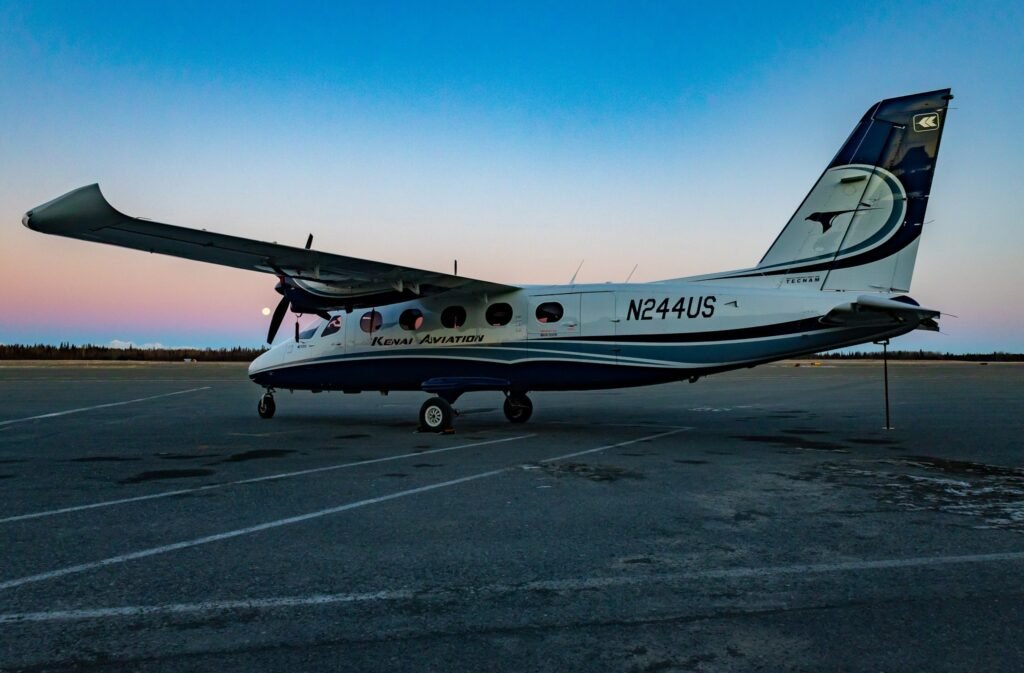 Anchorage, United States: Regional carrier Kenai Aviation has announced an immediate shutdown of all operations, citing severe financial distress and aircraft maintenance issues that have rendered continued service impossible. The abrupt closure has left several Alaska communities without scheduled passenger air service, raising concerns over rural connectivity in the state. In a message posted on the company’s website on Monday, Kenai Aviation owner Joel Caldwell said he was “devastated” by the decision but could no longer sustain operations amid mounting debt. “We have to cease all operations immediately. I am devastated,” Caldwell wrote. “Our operations may stop, but this vision continues… I believe that Flight 114 will board again. We need capital, we need partners, we need a lifeline.” Founded in 1959, Kenai Aviation originally supported Cook Inlet’s oil and gas operations before expanding into passenger and charter services across south-central Alaska. Caldwell acquired the company in 2018 and attempted to modernize its fleet and restart scheduled service to underserved communities. The company faced a growing debt burden dating back to the pandemic period, which intensified after its King Air aircraft, a key asset serving the Anchorage Unalakleet route, was grounded for maintenance. The setback severely affected the carrier’s ability to maintain service reliability and cash flow. “Kenai Aviation has been struggling to keep up with the cost of operations in an environment where rising fuel, maintenance, and insurance expenses are hitting small regional carriers hardest,” the ADN report stated. Earlier in 2025, the airline’s performance had already been under scrutiny when data showed that only about 45% of scheduled flights between Anchorage and Unalakleet were completed during a three-week span starting in July. The shutdown is a major blow to Unalakleet, a western Alaska community that relied on Kenai Aviation for passenger travel and cargo. With the airline’s exit, the village now lacks a regularly scheduled passenger carrier. Kenai Aviation’s departure could disrupt essential mobility for residents and delay medical, educational, and commercial travel. The U.S. Department of Transportation (DOT) is expected to reassign the Essential Air Service (EAS) contract for the affected route, though no replacement operator has yet been confirmed.