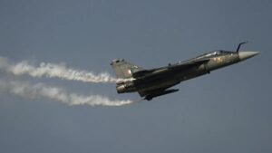 Dubai, United Arab Emirates: A HAL Tejas combat fighter aircraft of the Indian Air Force crashed on Friday afternoon during a demonstration sortie at the Dubai Airshow, triggering an immediate response from emergency crews and prompting organisers to suspend flying displays for the day. The crash occurred at approximately 2:10 pm local time at Al Maktoum International Airport, where the biennial event is being held. Witnesses reported seeing the aircraft lose control mid-maneuver before descending rapidly and erupting into flames. Thick black smoke was visible from several parts of the airshow grounds. The Indian Air Force confirmed that the pilot tragically lost his life in the crash. Authorities responded immediately at the scene, and airshow organisers suspended flying displays for the day. The accident follows an online speculation after videos circulated on 18 November 2025, claiming an aircraft had leaked oil during pre-flight ground operations. On 20th November2025, India’s Press Information Bureau, citing technical inputs, dismissed the claims and clarified that the fluid seen in videos was condensed water drained from the aircraft’s Environmental Control System (ECS) and On-Board Oxygen Generating System (OBOGS) both of which routinely expel moisture in hot, humid conditions like Dubai. The Ministry of Defence also termed the online posts “fake”, accusing certain accounts of attempting to discredit the made-in-India fighter. India had positioned the Tejas as a highlight of its participation at the Dubai Airshow, aiming to demonstrate its indigenous fighter programme to potential export customers. The crash is expected to draw scrutiny from aviation regulators, technical evaluators and defence analysts. Experts say the outcome of the investigation particularly whether the cause was mechanical, environmental or pilot-related will influence future display permissions and export prospects. A joint inquiry involving UAE aviation authorities, the Indian Air Force and Hindustan Aeronautics Limited (HAL) is expected to begin shortly. Access to the crash site has been restricted, and debris recovery operations are underway. Airshow organisers briefly halted public movement in open areas after the incident and redirected visitors to indoor exhibition halls. On 12 March 2024, a Tejas light combat aircraft of the Indian Air Force crashed near Jaisalmer in Rajasthan during an operational training sortie, marking the first crash of the indigenous jet in its 23-year history. The pilot ejected safely, and although the aircraft crashed into a building, there were no civilian injuries.