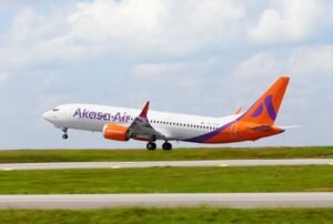 New Delhi, India: Flight operations across several Indian carriers were disrupted on Tuesday after volcanic ash from Ethiopia’s Hayli Gubbi eruption drifted toward major West Asia and India-bound air corridors. Airlines including Air India, Akasa Air and IndiGo cancelled or rerouted multiple flights as the Directorate General of Civil Aviation (DGCA) issued an urgent advisory enforcing strict avoidance of ash-affected airspace. The DGCA directed airlines to steer clear of regions and flight levels identified as contaminated by volcanic ash. The regulator also instructed carriers to reassess flight plans, fuel requirements and alternates, and to file immediate reports of any suspected ash encounters. The advisory highlighted the risk to aircraft engines and airframes, and asked operators to conduct additional inspections for any aircraft that may have flown near the affected zones. Airports were simultaneously ordered to check runways, aprons and taxiways for possible ash contamination and initiate cleaning procedures if required. Air India cancelled 11 flights over the past 24 hours, stating that precautionary checks were needed on aircraft that might have traversed areas close to the ash plume. The airline said it was monitoring volcanic-ash advisories in coordination with international aviation agencies and had not observed any major operational impact beyond temporary cancellations. Akasa Air suspended several India–Gulf flights, including services to Jeddah, Kuwait and Abu Dhabi, citing the need to avoid ash-affected airspace over the Arabian Peninsula. The airline offered full refunds and complimentary rebooking for passengers scheduled to travel on 24 and 25 November. IndiGo reported multiple cancellations as well, noting that its operations team was adjusting routes in real time based on ash-movement maps issued by global meteorological centres. At least six flights including services from Mumbai and southern metros were grounded as a precaution. Volcanic ash can severely damage aircraft by melting inside engines, clogging ventilation systems and affecting sensors. Following ICAO protocols, Indian carriers have shifted flight paths and temporarily halted services operating along westbound routes that intersect the plume’s trajectory. Although the ash cloud was observed at high altitudes reducing the likelihood of direct impact on surface visibility, aviation authorities stressed that even small concentrations can be hazardous for high-altitude jet operations. Meteorological agencies indicated that the ash plume continued its eastward movement toward China after passing over northern India. Airlines said normal operations would resume once updated advisories confirm the clearing of affected corridors. Indian regulators and carriers remain on heightened watch, treating the event as a significant international air-safety incident requiring continuous monitoring.