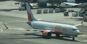 Tiruchirappalli, India: A Dubai-bound Air India Express flight was forced to make an emergency landing at Tiruchirappalli International Airport on Monday after the crew detected a technical malfunction shortly after take-off. The aircraft landed safely after remaining airborne for nearly two hours as part of standard safety procedures. No injuries were reported. The aircraft, operating as Flight IX 611, departed Trichy at around 1:55 PM, carrying approximately 152 people onboard, after a brief delay from its scheduled departure time of 12:45 PM. Soon after take-off, pilots reported a technical snag and immediately entered a holding pattern over the Tiruchirappalli and Pudukottai airspace to burn excess fuel before attempting a safe landing. After circling for nearly two hours, the aircraft touched down safely at 3:53 PM, triggering emergency protocols at the airport. Fire and rescue services remained on standby as a precautionary measure. Airport sources said 11 passengers were offloaded following the return. The remaining 135 travellers, along with six crew members, were shifted to another aircraft through a one-to-one transfer process. Air India Express has not yet disclosed the exact nature of the technical fault. Officials confirmed that a detailed investigation will be conducted in line with aviation safety protocols. Airport authorities stated that the incident was handled efficiently and that passenger safety was never compromised. Several passengers reportedly contacted relatives after noticing the aircraft was not gaining cruising altitude, sparking momentary concern before the safe landing was confirmed. The Directorate General of Civil Aviation (DGCA) is expected to review the technical report once it is submitted by the airline.