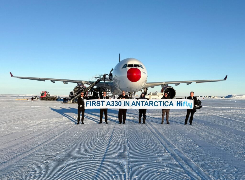 Cape Town, Antarctica: Portuguese charter airline Hi Fly has successfully completed the world’s first Airbus A330 landing on an Antarctic ice runway, marking a major milestone in the evolution of polar aviation. The aircraft touched down at Wolf’s Fang Runway in Queen Maud Land after departing from Cape Town, South Africa. The historic flight was operated using an Airbus A330-302 registered as 9H-HFI and was commanded by Hi Fly Vice-Chairman Captain Carlos Mirpuri, who has previously led several pioneering polar operations for the airline. The mission was conducted on behalf of luxury expedition operator White Desert Antarctica as part of the 2025–26 Antarctic summer season. Wolf’s Fang Runway is a blue-ice airstrip carved out of glacial ice and used for logistics, scientific operations and high-end tourism. In November 2021, Hi Fly made global aviation history by becoming the first airline to land a widebody commercial jet on an Antarctic ice runway. The aircraft used was an Airbus A340-300, which touched down on the blue-ice Wolf’s Fang Runway in the interior of Antarctica. The deployment of the A330 was made possible following recent upgrades to ground-handling and runway-support infrastructure at Wolf’s Fang. These improvements now allow safe operations of modern twin-engine widebody aircraft in one of the world’s most challenging aviation environments. The shift from the four-engine A340 to the twin-engine A330 also brings significant environmental and efficiency benefits. The A330 offers lower fuel consumption, reduced emissions and improved operating economics, aligning with growing sustainability expectations for Antarctic operations. Aviation analysts say the successful A330 landing sets a new benchmark for polar operations and opens the door for broader use of modern, fuel-efficient aircraft for both tourism and scientific logistics in Antarctica. With expanding infrastructure and proven aircraft capability, operators could increasingly rely on twin-engine widebodies for future missions. While Russian cargo jets and military aircraft had operated on Antarctic ice runways earlier, Hi Fly became the first commercial airline to land a widebody passenger jet on Wolf’s Fang Runway in Antarctica’s interior in 2021, followed by the world’s first Airbus A330 ice-runway landing in 2025. For White Desert Antarctica, the milestone strengthens its ability to transport guests, researchers and critical supplies to one of the most remote locations on Earth with improved capacity and lower environmental impact.