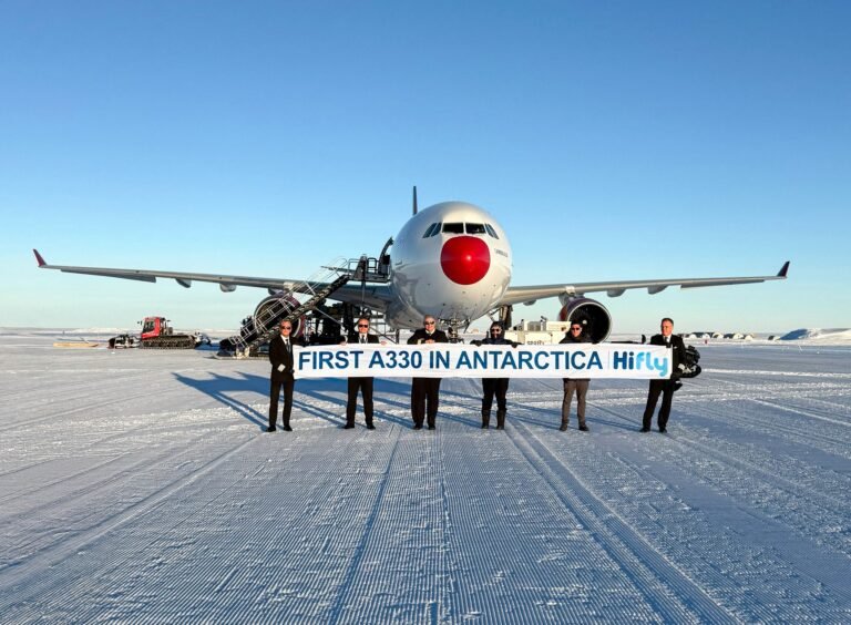 Cape Town, Antarctica: Portuguese charter airline Hi Fly has successfully completed the world’s first Airbus A330 landing on an Antarctic ice runway, marking a major milestone in the evolution of polar aviation. The aircraft touched down at Wolf’s Fang Runway in Queen Maud Land after departing from Cape Town, South Africa. The historic flight was operated using an Airbus A330-302 registered as 9H-HFI and was commanded by Hi Fly Vice-Chairman Captain Carlos Mirpuri, who has previously led several pioneering polar operations for the airline. The mission was conducted on behalf of luxury expedition operator White Desert Antarctica as part of the 2025–26 Antarctic summer season. Wolf’s Fang Runway is a blue-ice airstrip carved out of glacial ice and used for logistics, scientific operations and high-end tourism. In November 2021, Hi Fly made global aviation history by becoming the first airline to land a widebody commercial jet on an Antarctic ice runway. The aircraft used was an Airbus A340-300, which touched down on the blue-ice Wolf’s Fang Runway in the interior of Antarctica. The deployment of the A330 was made possible following recent upgrades to ground-handling and runway-support infrastructure at Wolf’s Fang. These improvements now allow safe operations of modern twin-engine widebody aircraft in one of the world’s most challenging aviation environments. The shift from the four-engine A340 to the twin-engine A330 also brings significant environmental and efficiency benefits. The A330 offers lower fuel consumption, reduced emissions and improved operating economics, aligning with growing sustainability expectations for Antarctic operations. Aviation analysts say the successful A330 landing sets a new benchmark for polar operations and opens the door for broader use of modern, fuel-efficient aircraft for both tourism and scientific logistics in Antarctica. With expanding infrastructure and proven aircraft capability, operators could increasingly rely on twin-engine widebodies for future missions. While Russian cargo jets and military aircraft had operated on Antarctic ice runways earlier, Hi Fly became the first commercial airline to land a widebody passenger jet on Wolf’s Fang Runway in Antarctica’s interior in 2021, followed by the world’s first Airbus A330 ice-runway landing in 2025. For White Desert Antarctica, the milestone strengthens its ability to transport guests, researchers and critical supplies to one of the most remote locations on Earth with improved capacity and lower environmental impact.