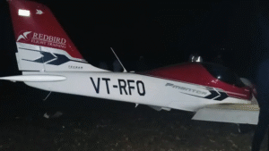 Seoni, India: A training aircraft belonging to Redbird Flight Training Academy crashed on Monday evening after its wing struck a 33 kV high-voltage power line near Sukatra village, in the Kurai police-station area of Seoni district. According to police, the incident occurred around 6:25–6:30 pm, roughly 2 km from the Suktara airstrip, as the aircraft was preparing to land. Eyewitness accounts describe sparks and a loud explosion as the plane’s wing contacted the line, after which the aircraft plunged into a nearby field. Authorities identified those on board as the instructor pilot Ajit Anthony and trainee pilot Ashok Chawda. Both sustained injuries and were taken to a private hospital in Barapathar. Officials say they are “out of danger.” Local police and power-company staff, aided by villagers, rescued the two pilots from the wreckage soon after the crash. A preliminary probe indicates that the aircraft may have suffered a “technical snag,” possibly an engine malfunction, causing it to lose power as it descended. The wing then struck the overhead power line of the Badalpar Substation, triggering the crash. The impact caused the 33 kV line to snap, immediately tripping the electricity supply. Roughly 80–90 villages around the substations reportedly experienced a blackout, and repair crews have been deployed to restore power to the affected areas. The district police have launched an official investigation to ascertain the precise cause of the crash. It remains uncertain whether pilot error, mechanical failure, or a combination of factors led to the collision. Final determination will await the outcome of the inquiry. So far, there have been no fatalities. Residents near the Suktara airstrip, however, expressed deep concern, noting that this was not the first incident involving a training aircraft in the area. Earlier in May 2025, a training aircraft operated by Redbird Aviation Pvt. Ltd. overturned during landing at the Suktara airstrip in Seoni district, Madhya Pradesh. The flight was being conducted solo by a trainee pilot. Initial reports attribute the incident to a faulty landing. Fortunately, the trainee escaped without injury and there was no fire. Months later on August 9, 2025 again a trainer aircraft of Redbird Flight Training Centre crash-landed near Baramati Airport in Pune district. During a routine training sortie at around 8 a.m., the trainee pilot realised one of the aircraft’s tyres was damaged. Upon touchdown, the front wheel detached and the aircraft veered off the taxiway, crossing to the far side of the airfield. Despite the abrupt landing and loss of the wheel, the pilot escaped unhurt.