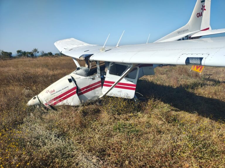 Seoni, India: A training aircraft belonging to Chimes Aviation Academy (CAA) skidded off the runway at Dhana Airstrip on Wednesday. The sole pilot aboard escaped without injury, police said. According to Additional Superintendent of Police Lokendra Singh, the aircraft veered off during take‑off and nosedived into scrubland adjacent to the airstrip just as authorities were preparing the runway for an emergency airlift of an injured soldier. “The solo pilot miraculously escaped without injuries,” he told IANS. Eyewitnesses described a sudden loss of control, followed by a plume of dust and debris as the plane left the runway and hit rough terrain. The aircraft reportedly did not catch fire, and there was no immediate sign of a major structural breakup. Dhana Airstrip located in Sagar district serves as the primary training base for Chimes Aviation Academy. CAA lists the Dhana facility among its certified flying bases. The accident renews scrutiny over repeated safety‑related incidents at Dhana. CAA and the local administration have not yet released a detailed statement. An investigation is expected to determine whether pilot error, technical failure or runway/airstrip conditions caused the mishap. Similar Training Aircraft Crash At Seoni Two Days Ago About two days ago, a training aircraft belonging to Redbird Flight Training Academy crashed near Seoni district in Madhya Pradesh. According to police and local reports, the aircraft struck a 33 kV high‑voltage power line while preparing to land near the village of Amgaon, roughly 2 km from Suktara Airstrip. The wing’s impact severed the line, leading to a crash in a nearby field; both the pilot and the flight instructor identified as Ajit Anthony (instructor) and Ajit Chawda (trainee) sustained injuries but are now out of danger. In addition to the human injuries, the accident caused electricity disruption around 80–90 villages under the local power‑substation were plunged into darkness. Previous Training Aircraft Incidents at Chimes Aviation Academy 6 April 2009, a training aircraft of Chimes Aviation Academy, a Cessna 172R registered VT‑CAI departed from Dhana Airstrip on a cross‑country solo training flight. On its return leg near Bargi Dam in Madhya Pradesh, the aircraft reportedly flew very low over the water, made a low pass near fishermen, and then plunged into the dam. The wreckage was recovered on 29 May 2009, after more than a month, with the aircraft destroyed, the engine hanging and the propeller facing downward. The lone trainee pilot on board tragically died. 3 January 2020, Dhana Airstrip, Sagar (MP), a Cessna 172 training aircraft of Chimes Aviation Academy crashed during landing at Dhana Airstrip. Both the instructor and trainee on board tragically lost their lives in the accident 17 July 2021, Dhana Airstrip, Sagar, a Cessna 172R (VT‑CAG) operated by the academy experienced a runway excursion during take‑off or landing at Dhana Airstrip. The aircraft skidded off the runway, but the trainee pilot escaped unhurt. 6 March 2024, Guna Airstrip, Guna district (MP), a Cessna 172S (VT‑CHP) developed engine trouble mid-flight while traveling from Neemuch to Dhana. The trainee pilot attempted an emergency landing at Guna Airstrip but lost control, crashing into bushes. The pilot was injured, and the aircraft sustained substantial damage.