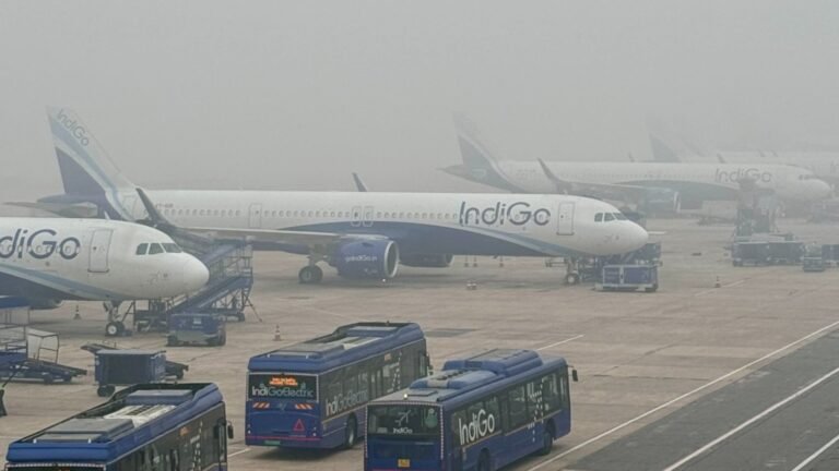 New Delhi, India: India’s Civil Aviation regulator, the Directorate General of Civil Aviation (DGCA), has dismissed four senior flight operations inspectors amid ongoing operational disruptions at IndiGo, the country’s largest airline, underscoring heightened regulatory scrutiny in the wake of a pilot staffing crisis that has triggered widespread flight cancellations across the domestic network. The DGCA acted on Friday after concluding that the inspectors tasked with monitoring safety and compliance at IndiGo failed to adequately oversee the airline’s preparedness, particularly in ensuring sufficient cockpit crew in line with newly implemented duty and rest norms. In a related move, DGCA teams have been deployed to IndiGo’s headquarters in Gurugram, where officials are monitoring daily operations including crew deployment, flight cancellations, unplanned pilot leave and passenger refunds. These teams are required to submit daily reports to the regulator as the investigation continues. The regulatory action follows a series of disruptions that began in early December, when IndiGo began cancelling large numbers of flights reportedly thousands nationwide after tighter Flight Duty Time Limitation (FDTL) rules came into full effect on November 1. These rules, designed to extend mandatory rest periods and limit duty hours for pilots, significantly reduced the number of permissible night landings and imposed greater rest requirements. Parliamentary data indicates IndiGo’s pilot count dropped to approximately 5,085 by early December, down from around 5,463 in March 2025, exacerbating the strain on flight operations as rest norms tightened. Industry and pilot association sources have criticised IndiGo’s staffing strategy, arguing that the airline did not hire sufficient pilots or adjust crew rostering in anticipation of the FDTL rules, despite a two‑year preparatory window. The Federation of Indian Pilots (FIP) described the airline’s approach as a “prolonged and unorthodox lean manpower strategy,” contending it worsened the impact of the new norms. Earlier in a significant regulatory intervention, the Directorate General of Civil Aviation (DGCA) has ordered IndiGo to cut approximately 10 % of its winter flight schedule, a move that could result in more than 200 fewer daily operations for India’s largest carrier as it grapples with widespread cancellations and pilot staffing shortfalls. The directive comes after an intensive review of the airline’s ability to operate the winter schedule safely and reliably amid ongoing disruptions that began in early December, with regulators finding that IndiGo had “not demonstrated an ability to operate these schedules efficiently.” Under the new order, the airline has been instructed to revise its winter roster and scale down services, particularly on routes where alternative options exist, in a bid to stabilise operations through the winter period that runs until late March 2026. The reduction is part of broader oversight action by DGCA, which has also deployed monitoring teams and summoned the airline’s senior management to explain its operational planning. In a further escalation, the DGCA has summoned IndiGo CEO Pieter Elbers to appear before an investigative panel on December 12 to explain the airline’s planning and management of its flight operations during the crisis. Elbers previously appeared before the panel, which is also examining manpower planning, rostering systems and compliance readiness under the FDTL framework. To address the pilot shortage, IndiGo has submitted a comprehensive manpower plan to the regulator, outlining targets to expand its flight crew through both domestic recruitment and the hiring of expatriate pilots. The airline aims to recruit several hundred additional captains and first officers by early 2026. Civil Aviation Minister K. Ram Mohan Naidu has publicly rejected claims that regulatory oversight lapses caused the disruptions, placing primary responsibility on IndiGo’s internal management and rostering failures. He also highlighted the need for broader structural reforms in India’s aviation sector to prevent over‑reliance on a single major carrier. The crisis has intensified debate over airline preparedness, regulatory implementation and passenger rights, with government officials, industry analysts and pilots weighing in on both operational planning failures and the challenges posed by the new safety‑oriented duty norms.