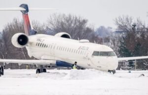 Des Moines, United States: A regional jet operated by Endeavor Air under the Delta Connection brand slid off the runway while landing at Des Moines International Airport late Saturday night. All 54 passengers and four crew members were evacuated safely, and no injuries have been reported. Flight 5087, arriving from Detroit Metropolitan Wayne County Airport, landed at Des Moines International Airport at approximately 9:30 p.m. local time. According to airport officials, icy conditions on the snow-covered runway caused the aircraft to skid off the taxiway after landing. The aircraft came to rest beyond the end of the runway. “The safety of our passengers and crew is our top priority,” Delta said in a statement, adding that operations were temporarily disrupted as a result of the incident. All passengers and crew were safely evacuated via stairs and transported back to the terminal by buses. Local authorities confirmed there were no injuries, and emergency response teams were on-site to assist with the evacuation. The runway slide forced Des Moines International Airport to close for several hours. Flights were delayed or canceled as airport personnel worked to secure the aircraft and ensure the runway was safe for operations. The airport reopened by mid-morning on Sunday, though some flights continued to experience delays. The incident occurred during a severe winter storm that brought heavy snowfall and icy conditions to the region, creating hazardous conditions for air and ground travel. The Federal Aviation Administration (FAA) is aware of the incident, and the National Transportation Safety Board (NTSB) is collecting information. Airport and airline officials emphasized that icy runway conditions were the primary factor in the excursion.