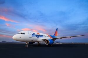 Las Vegas, United States: U.S. low-cost carrier Allegiant Travel Company has reached a definitive agreement to acquire rival Sun Country Airlines in a cash-and-stock transaction valued at approximately USD 1.5 billion, marking a significant consolidation in the nation’s leisure airline segment. Under the terms of the deal announced Sunday, Sun Country shareholders will receive 0.1557 shares of Allegiant common stock and USD 4.10 in cash for each share held, valuing Sun Country equity at about USD 18.89 per share a premium of nearly 19.8% over the airline’s closing price prior to the announcement. The enterprise value includes around USD 400 million of Sun Country’s net debt. The combined airline will operate under the Allegiant name and be headquartered in Las Vegas, with a significant operational presence maintained in Minneapolis–Saint Paul, Sun Country’s home base. The boards of both carriers have unanimously approved the transaction, which is expected to close in the second half of 2026, subject to regulatory and shareholder approvals. Once completed, the merged carrier will serve nearly 175 cities with more than 650 routes and operate an expanded fleet of about 195 aircraft, including additional orders and options across Boeing and Airbus models. The combination broadens Allegiant’s traditional focus on small and mid-sized U.S. markets with Sun Country’s larger city footprints and international leisure destinations in Mexico, the Caribbean, Canada and Central America. Allegiant Chief Executive Officer Gregory C. Anderson said the merger would strengthen both airlines’ shared mission “in providing affordable, reliable, and convenient service from underserved communities to premier leisure destinations,” citing complementary networks and expanded international opportunities. Sun Country President and CEO Jude Bricker described the deal as delivering “significant value” to shareholders and customers. Allegiant anticipates approximately USD 140 million in annual synergies within three years of closing, driven by scale efficiencies, fleet optimization and integrated scheduling. The transaction is also expected to be accretive to earnings per share in the first year after closing. Following completion, Allegiant shareholders will own about 67% of the combined company, with Sun Country shareholders holding roughly 33% on a fully diluted basis. Anderson will remain chief executive officer of the combined airline, with Robert Neal named president and chief financial officer. Bricker will join the combined board of directors. Despite the merger, both carriers will continue operating independently under their current brands until they receive a single operating certificate from the Federal Aviation Administration (FAA), a process that typically unfolds over several months. Allegiant and Sun Country have stated that the transaction will have no immediate effect on ticketing, flight schedules or customer experience. The agreement comes amid broader consolidation trends in the U.S. airline industry, particularly among low-cost and leisure carriers seeking to boost competitiveness against larger legacy airlines.