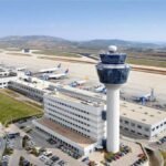 Athens, Greece: A government-appointed investigation has concluded that last week’s eight-hour communications blackout in Greek airspace at Athens International Airport was caused by outdated and unsynchronised systems, not a cyberattack, exposing critical infrastructure vulnerabilities in one of Europe’s busiest flight regions. On January 4, radio communications across the Athens Flight Information Region (FIR) collapsed in a “blackout” that forced authorities to clear the airspace, ground departures and divert incoming flights for several hours. The incident left thousands of passengers stranded and triggered delays that rippled through European air traffic networks. According to the official report submitted to Infrastructure and Transport Minister Christos Dimas, the root cause was desynchronisation and “digital noise” in legacy telecommunications hardware supporting the Greek Civil Aviation Authority’s (HCAA) voice communication system. The systems rely on Synchronous Digital Hierarchy (SDH) technology no longer supported by manufacturers, leaving them vulnerable to failures without modern operational guarantees. The expert panel, which included representatives from the HCAA, national cybersecurity authority, telecom regulator and EUROCONTROL, confirmed there were no indications of a cyberattack or external interference. Full restoration occurred after telecommunications circuits were resynchronised and rerouted, with services returning to normal by approximately 16:53 local time. The incident was classified as “low risk” under aviation safety reporting criteria, with no breaches of minimum separation standards or evidence that aircraft were exposed to direct threat, according to the report. In the wake of the findings, HCAA governor Giorgos Saounatsos resigned at the request of Minister Dimas, who said the report underscored serious weaknesses in air traffic management infrastructure. Deputy governor Giorgos Vagenas will serve as interim head while the process to appoint a new administrator begins. The investigative committee recommended a rapid transition to Voice over IP (VoIP) communications, acquisition of nearly 500 new transceivers, and the establishment of a permanent joint crisis-response mechanism between the HCAA and national telecom provider OTE. It also called for improved remote monitoring, stronger spectrum oversight and relocation of critical facilities to reduce systemic risk. A ministry statement said plans to modernise Greece’s air traffic communications are underway but not expected to be complete before 2028, leaving systemic vulnerabilities in place as the nation prepares for its peak summer travel season. Air traffic controllers’ unions and aviation safety experts have long warned that ageing infrastructure and equipment obsolescence posed escalating operational risks. Following release of the committee’s findings, controllers stressed that safety on January 4 was maintained chiefly through manual procedures and emergency protocols, not because of robust systems. They have urged immediate action to align Greece’s air navigation capabilities with modern European standards.