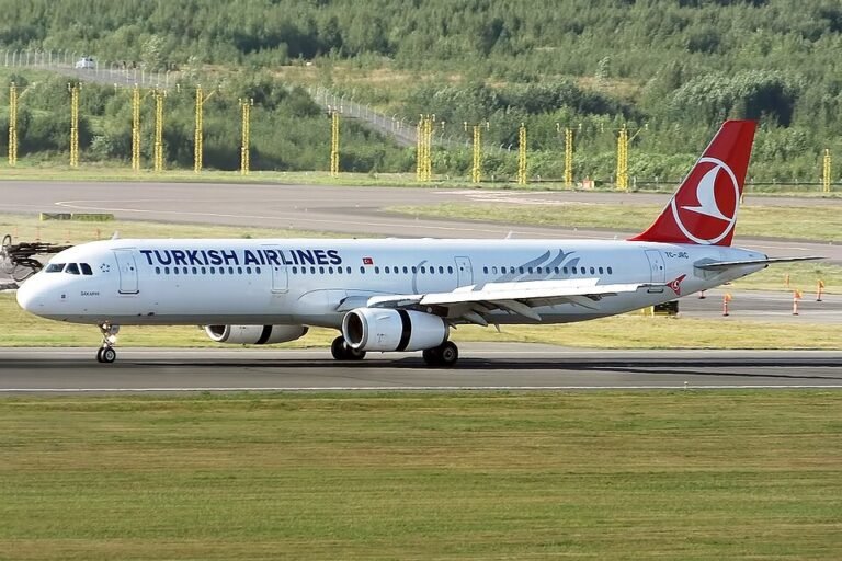 Barcelona, Spain: A Turkish Airlines Airbus A321, operating Flight TK1853 from Istanbul to Barcelona, carried out an emergency landing at Josep Tarradellas Barcelona‑El Prat Airport on Thursday morning after authorities received what was initially perceived as a bomb threat on board. The incident unfolded in the final phase of the flight, which departed Istanbul at approximately 9:22 a.m. local time and was scheduled to arrive in Barcelona around 11 a.m. As the aircraft was approaching its destination with 148 passengers and 7 crew members onboard, flight crew members were alerted to a suspicious in‑flight wireless network name that appeared to include threatening language interpreted as a bomb warning. In response to the alert, the airline’s regional communications executive, Yahya Üstün, confirmed that the crew declared an emergency and implemented standard safety protocols. Spanish authorities also activated the Aerocat emergency plan, mobilising airport security forces, fire services and the Guardia Civil to manage the situation and ensure safety. The aircraft was directed to a designated remote area of the airport upon landing at 10:57 a.m., where passengers disembarked safely and were escorted to secure facilities away from terminal operations. According to local officials, Barcelona‑El Prat continued to operate normally throughout the incident. Security personnel conducted thorough inspections of the aircraft, luggage and passengers. No explosives or hazardous materials were found, and authorities later confirmed the threat was a false alarm. Spanish and Catalan police forces led the on‑ground response, supported by civil protection units and regional emergency services. Passengers remained in secure areas while officials completed safety checks and de-escalated the risk. According to Turkish Airlines, the incident appears to have been triggered by the Wi‑Fi hotspot name created by a passenger, which included text interpreted as a bomb threat. The airline said it has initiated procedures to identify the individual responsible and will cooperate with the Spanish investigation. In a statement posted on social media platform X, Turkish Airlines reaffirmed that no irregularities were detected after security screenings, and that the aircraft’s return flight was scheduled.