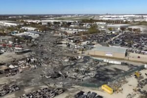 Louisville, United States: Federal investigators have identified a crucial aircraft component with a known history of failures as a key focus in the ongoing probe into the UPS Cargo Flight 2976 crash that killed 15 people in November 2025. The National Transportation Safety Board (NTSB) disclosed this week that the metal housing around a spherical bearing assembly part of the structure securing the left engine to the wing on the McDonnell Douglas MD-11F freighter exhibited signs of metal fatigue and cracking before breaking during takeoff. The failure of this part is believed to have precipitated the catastrophic sequence that ended in the fatal crash. Flight 2976 departed from Louisville Muhammad Ali International Airport on Nov. 4, 2025, bound for Honolulu, Hawaii. Seconds after beginning its takeoff roll on Runway 17R, the aircraft’s left engine and its pylon separated from the wing. Surveillance footage reviewed by investigators shows the engine detaching and vaulting up and over the fuselage as the freighter lifted briefly into the air before descending into an industrial area just beyond the airport perimeter. The crash claimed the lives of all three crewmembers aboard and 12 people on the ground, and left numerous others injured. The NTSB has confirmed the component at the center of the investigation, the metal housing around the spherical bearing connecting the engine pylon to the wing had a documented history of four prior failures on other MD-11 aircraft, according to a Boeing service advisory issued in 2011. At that time, Boeing, which later acquired McDonnell Douglas, determined the issue did not constitute a “safety-of-flight condition” and recommended visual inspections rather than a mandatory redesign. The advisory also suggested a newer version of the part that eliminated the design feature where cracks can initiate, but did not compel operators to adopt it. Investigators are now reviewing how that advisory was incorporated into routine maintenance and whether inspectors and operators, including UPS, followed the recommendations. Preliminary NTSB findings show that detailed inspections of the engine mount parts were last performed in October 2021, and the aircraft was not scheduled for another detailed check until several thousand more flight cycles were completed. Critics have questioned whether the existing inspection intervals were sufficient to detect the developing fatigue cracks. The MD-11 involved was 34 years old, an age at which structural components on aircraft are more susceptible to wear and fatigue. All MD-11 and related DC-10 models remain grounded across U.S. cargo fleets pending enhanced inspections and corrective actions. The NTSB has recovered both the flight data recorder (FDR) and the cockpit voice recorder (CVR). Analysis of the cockpit recordings and detailed metallurgical examinations of the fractured parts continue as investigators work toward a final probable cause determination. The board has not yet released a complete conclusion on the chain of failures that led to the engine separation. UPS has reiterated its cooperation with the ongoing investigation and expressed condolences to victims’ families. Boeing has acknowledged the probe but has not issued further comment beyond confirming the existence of the earlier service advisory.