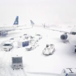 Winter Storm Disrupts Over 6,400 U.S. Flights Across The East Coast Amid Heavy Snow SEO DES: New York City Mayor Zohran Mamdani declared a state of emergency and travel ban, Blizzard warnings across the Northeast affecting 35M residents SOCIAL: A powerful Nor’easter blizzard hit the U.S. Northeast over the weekend, leaving thousands of travelers stranded and grounding major airports. As of Monday, over 6,400 flights were cancelled at key hubs including JFK, LaGuardia, Newark, and Boston Logan. The storm brought heavy snow, winds up to 70 mph, and white-out conditions, prompting emergency declarations, citywide travel bans, school closures, and transit suspensions. Airlines including Air India, Delta, American, JetBlue, United, Southwest, Alaska, and Spirit cancelled multiple flights. New York City Mayor Zohran Mamdani declared a state of emergency, and blizzard warnings across New Jersey, Connecticut, Massachusetts, and New England affected more than 35 million residents. Authorities deployed the National Guard and warned of ongoing hazardous conditions. New York, United States: A powerful Nor’easter blizzard that swept across the U.S. Northeast over the weekend has left thousands of travelers stranded and major airports nearly paralyzed. As of Monday morning, more than 6,400 flights have been cancelled across the region, with major hubs including JFK, LaGuardia, Newark, and Boston Logan International Airport reporting near-total shutdowns. The storm, driven by heavy snowfall, high winds, and white-out conditions, prompted emergency declarations, citywide travel bans, and school closures from New York City through New England and New Jersey. Meteorologists reported snow accumulations of up to 2 feet (60 cm) and wind gusts reaching 70 mph, creating hazardous conditions for road and air travel. According to flight-tracking data: Boston Logan International Airport saw 389 flight cancellations and 125 delays, affecting carriers including JetBlue (122 cancellations), Republic Airways (113), Delta (38), American (34), Southwest (21), and United (18). LaGuardia Airport cancelled approximately 98% of scheduled flights, while JFK reported 87% of departures and 85% of arrivals cancelled, and Newark Liberty International Airport experienced 83% of departures grounded. Air India cancelled all flights between New York and Newark for Monday and extended cancellations through Tuesday, Feb. 24. Other major carriers such as Delta, American, JetBlue, United, Southwest, Alaska Airlines, and Spirit also suspended numerous flights to safeguard passengers and crews. Airline and airport authorities urged travelers to check the latest flight updates and refrain from non-essential travel. Rebooking and refund requests are being processed by customer service teams as operations slowly resume. New York City Mayor Zohran Mamdani declared a state of emergency and imposed a citywide travel ban restricting non-essential travel. Blizzard warnings extended across New Jersey, Connecticut, Massachusetts, and coastal New England, affecting more than 35 million residents. Regional transit systems, including NJ Transit and Boston-area rail networks, suspended services during peak storm hours. Authorities activated the National Guard in several states to assist with snow clearance and emergency response. Local officials warned of continued dangerous driving conditions, power outages, and potential coastal flooding as the storm moves eastward.