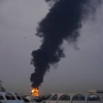 Drone Strike Near Dubai Airport Triggers Fire & Flight Suspensions Amid Gulf Crisis SEO DES: On the same day, UAE reported 6 missiles & 21 drones; Dubai airport was hit for the 3rd time in weeks with 7 deaths (5 civilians) & 145 injured since 28 Feb SOCIAL: A drone strike near Dubai International Airport on March 16 triggered a fuel tank fire, forcing temporary flight suspensions, delays, and airspace restrictions amid escalating regional conflict. The attack, part of a broader wave of drone and missile strikes targeting the UAE, caused widespread disruption with dozens of flights cancelled, diverted, or delayed, impacting major global and regional airlines. Authorities quickly contained the fire, enforced safety measures, and gradually resumed operations after clearance, with no casualties reported. Dubai, United Arab Emirates: An Iranian drone strike near Dubai International Airport triggered a major fuel tank fire on March 16, forcing a temporary suspension of flight operations and disrupting global air traffic, as tensions in the Middle East escalated sharply. According to multiple reports, the attack occurred early Monday (March 16) when a drone struck a fuel storage tank in the airport vicinity, sending thick plumes of smoke into the air and prompting immediate emergency response. Firefighters contained the blaze within hours, and no casualties were reported at the airport site. Airport operations were halted for several hours, with gradual resumption later the same day. Airspace closure lasted approximately 2 hours, affecting multiple inbound and outbound flights. Dozens of flights were cancelled, diverted, or returned mid-route. The incident is part of a wider wave of Iranian drone and missile attacks targeting the United Arab Emirates amid the ongoing Iran–US–Israel conflict, which began on February 28, 2026. On the same day, the UAE reported multiple incoming threats, including 6 ballistic missiles and 21 drones. The Dubai airport strike marked the third such incident targeting the airport in recent weeks, highlighting increasing risks to civilian aviation infrastructure. Since the start of the conflict, seven people including five civilians have been killed in the UAE and 145 have been injured, according to official figures from the Defense Ministry. Iran has sent 304 ballistic missiles, 15 cruise missiles and 1,627 drones to the UAE since Feb. 28, the Defense Ministry said in an update Monday. Additional drone-related fires were reported in Umm Al Quwain and Fujairah, indicating coordinated regional targeting. The attacks are widely seen as retaliation within the broader regional conflict, with Iran warning that strategic infrastructure in Gulf countries could be targeted. Authorities responded swiftly by halting flight operations and restricting airspace: Dubai airport suspended flights for several hours after the strike. The UAE temporarily closed its airspace for safety, leading to wider regional disruption. Foreign airline operations were suspended as a precautionary measure. Several flights were diverted to Al Maktoum International Airport and other regional hubs. In one notable case, an Emirates flight from Edinburgh was forced to turn back mid-air after nearly nine hours of flying, illustrating the scale of disruption. The disruption impacted several Indian airlines such as Air India, Air India Express, IndiGo, and SpiceJet suspended Dubai operations due to restrictions. Emirates temporarily halted operations before gradually resuming services after safety clearance. Etihad Airways and others adjusted schedules amid airspace uncertainty. Late on Monday, Dubai’s aviation regulator suspended landing permissions for foreign airlines at Dubai airports until further notice due to escalating regional tensions. British Airways suspended Dubai flights until at least June. Other major carriers including Air France, Lufthansa, and Virgin Atlantic also paused or rerouted services. Authorities implemented multiple safety and contingency measures, Dubai Civil Defence extinguished the fire and initiated cooling operations. Aviation authorities suspended landing permissions and advised passengers to avoid travel unless necessary. Roads near the airport were temporarily closed and later reopened. Flights resumed after safety assessments and clearance from authorities, with operations returning gradually to normal.