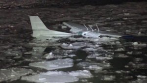 Small Training Aircraft Makes Emergency Landing In Hudson River, 2 Onboard Survive SEO DES: The aircraft, registered To American Airman Inc. was heavily damaged Both occupants were rescued by Coast Guard, Air Guard & police; FAA investigates SOCIAL: A small Cessna 172 training aircraft made a forced emergency landing on the icy Hudson River near the Newburgh–Beacon Bridge on the evening of March 2, 2026. The plane, which departed from Long Island MacArthur Airport, experienced in-flight difficulties and descended into the river around 7:55 p.m.. Both pilot and passenger survived with minor injuries. The aircraft, registered to American Airman Inc., sustained significant damage. A coordinated rescue involved the U.S. Coast Guard, Air National Guard, police, and fire departments. Authorities, including the FAA, are investigating the cause of the emergency landing. Officials praised first responders and likened the rescue to the 2009 “Miracle on the Hudson.” The flight had been following the Hudson River corridor, a common route for small aircraft, near Stewart International Airport, about 60 miles north of New York City. New York, United States: A small single-engine aircraft made a forced emergency landing on the icy waters of the Hudson River near the Newburgh-Beacon Bridge on the evening of Monday, March 2, 2026, authorities confirmed. The aircraft, a Cessna 172 Skyhawk, departed Long Island MacArthur Airport shortly before 7 p.m. local time and was later observed experiencing difficulties in flight, according to flight tracking and public reports. The pilot declared an emergency as the plane approached Stewart International Airport before descending into the Hudson River south of the bridge at around 7:55 p.m.. The aircraft bore the registration N1560E and is listed to American Airman Inc., a flight training organisation headquartered on Long Island, New York. The Cessna 172 is widely used in training and general aviation. Local officials and law enforcement confirmed that both people on board the pilot and a passenger survived the landing. They were recovered from the river and taken to nearby medical facilities. Early assessments indicate only minor injuries, and both individuals are expected to make a full recovery. The incident triggered a rapid and coordinated response from multiple agencies, including the U.S. Coast Guard, Air National Guard, state and local police, and fire departments. Emergency teams worked in freezing conditions amid floating river ice to locate and assist the occupants. New York Governor Kathy Hochul and Orange County Executive Steve Neuhaus praised the efforts of first responders. Neuhaus referenced the historic 2009 emergency landing on the Hudson of US Airways Flight 1549 dubbed the “Miracle on the Hudson” in commending the successful rescue of the smaller aircraft’s occupants. Initial reports suggest the Cessna sustained significant damage and may not be salvageable, with the wreckage expected to remain submerged and potentially serve as an artificial reef. The Federal Aviation Administration (FAA) has confirmed it is investigating the circumstances leading to the emergency landing. Official details on the cause whether mechanical failure, power loss, or another contributing factor have not yet been released. Final determination of the sequence of events will be part of the ongoing FAA inquiry. The flight had been transiting northward along the Hudson River corridor, a common route for small aircraft under visual flight rules prior to the emergency. The Hudson River under the Newburgh-Beacon Bridge lies roughly 60 miles north of New York City and is adjacent to general aviation traffic lanes near Stewart International Airport.