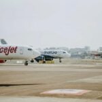 Govt Removes Fare Caps As Airlines Oppose 60% Seats Free Of Selection Charges SEO DES: Authorities want fair fares, but airlines warn lost add-on revenue may push base prices up, raising concerns over pricing freedom and financial strain SOCIAL: The government’s move to mandate 60% free seat selection and scrap fare caps has drawn strong opposition from airlines, which warn it could lead to higher ticket prices. While authorities have asked carriers to keep fares reasonable and transparent, airlines argue the loss of ancillary revenue may force them to raise base fares, raising concerns over pricing freedom, financial strain, and market impact. The earlier fare caps, which set limits based on distance, have now been withdrawn from March 23, 2026, restoring pricing flexibility to airlines. However, the move signals a shift toward self-regulation, with the government expecting airlines to balance affordability with market-driven pricing. New Delhi, India: A policy push by the government to strengthen passenger rights and enforce fare transparency has triggered sharp resistance from India’s leading airlines, setting the stage for a broader debate over pricing freedom and regulatory oversight in the aviation sector. The Ministry of Civil Aviation, through the Directorate General of Civil Aviation (DGCA), has directed carriers to ensure that at least 60% of seats on every flight are available for free selection, a move aimed at reducing ancillary charges and allowing passengers, particularly families booked under a single PNR, to be seated together without paying extra. The directive comes alongside a broader advisory asking airlines to maintain fares that are “reasonable, transparent and commensurate with market conditions,” even as the government transitions away from direct fare controls. Major carriers including Air India, IndiGo and SpiceJet have opposed the 60% free seat selection mandate, arguing that it interferes with their commercial pricing models and could have unintended financial consequences. Represented by the Federation of Indian Airlines (FIA), these carriers have formally approached the government, stating that seat selection fees form a critical component of ancillary revenues in an industry already operating on thin margins. Airlines contend that such non-ticket income helps offset high operating costs, including fuel, maintenance, and airport charges, and that restricting it would disrupt their financial balance. The government’s latest stance also marks a significant shift in its fare regulation approach. In its December 6 order, the ministry had imposed fare caps on economy class tickets, limiting prices to ₹7,500 for routes up to 500 km, ₹12,000 for distances between 500 and 1,000 km, ₹15,000 for sectors ranging from 1,000 to 1,500 km, and ₹18,000 for routes beyond 1,500 km, excluding taxes and additional fees. However, with operations now stabilised, the ministry has announced that these caps “shall stand withdrawn with effect from March 23, 2026,” effectively restoring pricing flexibility to airlines while simultaneously cautioning them against excessive or opaque fare structures. Airlines have warned that the combination of removing ancillary revenue streams through mandatory free seat allocation and expecting fare restraint could create financial strain. Industry executives argue that instead of lowering travel costs, the policy may inadvertently push up base fares as carriers attempt to recover lost income. This, they say, could neutralise the intended benefit for passengers and lead to a redistribution of costs rather than an actual reduction in overall ticket prices. The industry has also raised concerns about regulatory overreach, maintaining that fare determination in a competitive market should remain dynamic and driven by demand-supply factors. The market response has reflected these concerns, with airline stocks reacting negatively following the announcement, highlighting investor apprehension over potential revenue impacts. The ancillary revenues, including seat selection, baggage fees, and onboard services, have become an increasingly important part of airline business models globally, and any disruption to this stream could have wider financial implications. For passengers, the new framework promises immediate relief in terms of fewer add-on charges and improved seating convenience, particularly for families and groups. At the same time, the removal of fare caps theoretically allows for more competitive pricing, but also raises the risk of price volatility if not closely monitored. The government’s approach indicates a shift toward a hybrid model, where airlines are given pricing freedom but are expected to exercise self-regulation under regulatory scrutiny.