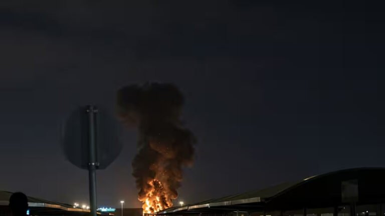 Drone Strike Triggers Fire At Kuwait International Airport Amid Escalating Gulf Crisis SEO DES: Kuwait has reported multiple recent attacks, including strikes on radar systems & fuel tanks, reflecting rising threats to critical aviation infrastructure SOCIAL: A drone strike hit a fuel tank at Kuwait International Airport in Kuwait City, Kuwait, triggering a fire that was quickly contained with no casualties and limited damage. The incident is part of a series of recent drone and missile attacks linked to escalating Iran-U.S.-Israel tensions, with authorities continuing investigations as regional security risks intensify. Kuwait has reported multiple similar attacks in recent weeks, including strikes on radar systems and fuel facilities, reflecting growing threats to critical aviation infrastructure. The situation reflects a broader regional escalation, with Gulf nations facing increased aerial threats and rising concerns over aviation safety and fuel supply stability. Kuwait City, Kuwait: A drone strike targeting fuel storage infrastructure at Kuwait International Airport triggered a fire on Wednesday, marking the latest escalation in a widening regional conflict linked to the ongoing Iran-U.S.-Israel tensions. According to Kuwait’s Civil Aviation Authority, the attack struck a fuel tank at the airport, causing a blaze that was swiftly contained by emergency response teams. Authorities confirmed that no casualties or injuries were reported, and initial assessments indicated that the damage was limited to infrastructure. Emergency protocols were immediately activated, with firefighting units responding to the scene and bringing the situation under control within a short period. Officials have not yet disclosed the origin of the drone or the group responsible, and investigations remain ongoing. Agency spokesman Abdullah Al-Rajhi said the impact was “limited,” confirming that firefighters were continuing operations to fully extinguish the blaze. Preliminary assessments indicated that the attack caused only material damage. The incident is not isolated. Kuwait has faced repeated drone and missile attacks in recent weeks, as regional tensions intensified following coordinated military actions involving Iran, the United States, and Israel. Wednesday’s strike is the latest in a string of attacks targeting Kuwait’s main airport since the conflict intensified on February 28. Earlier incidents include a March 14 drone strike on radar systems and a March 8 attack that damaged fuel storage facilities. A separate strike on a passenger terminal had left several people with minor injuries. Kuwait’s military has repeatedly reported “waves of hostile drones” entering its airspace, with air defense systems actively intercepting incoming threats. The attack comes amid a broader escalation in the Middle East, where Iran has launched drone and missile strikes targeting the U.S.-linked assets and allied countries across the Gulf, including Kuwait, Bahrain, and Jordan. Kuwait, which hosts U.S. military installations, has increasingly found itself exposed to retaliatory strikes as the conflict expands beyond its initial theaters. In recent weeks, the country has also reported casualties among security personnel and damage to infrastructure linked to ongoing aerial attacks, reflecting the persistent threat environment. Globally, the conflict has begun to impact aviation operations and fuel supply chains, with rising jet fuel prices and early signs of disruptions to flight networks in parts of Asia and beyond. Kuwaiti authorities continue to assess the full extent of the damage and are working to determine the source and intent behind the attack. No group has officially claimed responsibility so far.