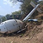 Nepal Helicopter Crash In Khotang During Landing, One Passenger Critically Injured SEO DES: The helicopter operated by Air Dynasty Heli Service carried five passengers and the body of a deceased individual for final rites when the incident occurred SOCIAL: A helicopter operated by Air Dynasty Heli Service crashed while landing in Balabesi, Khotang district of eastern Nepal, leaving one passenger injured while all others, including the pilot, were safe. The aircraft had departed from Kathmandu carrying five passengers and the body of a deceased person when it lost balance during touchdown on farmland around 11:51 a.m. local time and overturned. It sustained damage after rolling sideways on landing. Authorities confirmed no fatalities. The injured elderly passenger suffered leg and eye injuries and was airlifted to Kathmandu for treatment. Emergency responders and another helicopter from the same operator carried out rescue operations quickly. Preliminary reports suggest strong winds, dust reducing visibility, and loss of control during landing may have contributed, though the Civil Aviation Authority of Nepal has launched an investigation. Khotang, Nepal: A helicopter operated by Air Dynasty Heli Service Pvt. Ltd. crashed while attempting to land in Balabesi area of Khotang district in eastern Nepal on Wednesday, leaving one passenger critically injured while all other occupants survived with minor injuries, according to civil aviation officials and local authorities. The helicopter operated by pilot Sabin Thapa, had departed from Kathmandu, was carrying five passengers along with the body of a deceased individual being transported for final rites. The aircraft was attempting a landing on farmland in Balabesi around 11:51 a.m. local time when it suddenly lost balance and overturned upon touchdown. Officials confirmed that the helicopter hit the ground during its final approach and rolled sideways before coming to rest, sustaining significant damage. “No human casualties have been recorded. More details are due”, Rekha Kandel, chief district officer of Khotang district told ANI. The critically injured passenger, identified in local reports as an elderly man, 65, a resident of Lalitpur named Kaji Bahadur, suffered injuries to his leg and eye and was immediately airlifted to Kathmandu for advanced medical treatment using another helicopter dispatched from the same operator. The helicopter was carrying the lifeless body of Manalakshmi Rai, 77, a resident of Balabensi who passed away a month ago in the UK. The body as reported was being brought by her relatives for cremation. Also on board the helicopter were the deceased’s husband, Dakmani Rai, 83, son Balkumar Rai, 53, daughter Laxmi Rai, 47 and 40-year-old Samala Rai. Officials confirmed that all passengers along with the pilot Sabin Thapa were safely rescued from the crash site. Preliminary assessments suggest the crash may have been triggered by: Strong winds at the landing site Dust clouds reducing visibility during touchdown Loss of control during final landing phase Authorities have not confirmed the final cause, and a formal investigation has been launched by Nepal’s aviation regulator. Footage circulating online shows the helicopter descending normally before suddenly tipping on its side during landing. The aircraft then overturned on the uneven terrain, with locals rushing immediately to rescue passengers. Local residents, along with emergency responders, quickly reached the site and helped evacuate all occupants. Another Air Dynasty helicopter was deployed to transport the injured passenger and pilot to Kathmandu for treatment. Officials confirmed that emergency response operations were completed within a short time after the incident. The helicopter involved belongs to Air Dynasty Heli Service Pvt. Ltd., one of Nepal’s private helicopter operators frequently used for medical, rescue, and charter flights in mountainous regions. "One passenger on board the helicopter has been injured. The pilot and other passengers are safe. Another helicopter with registration number 9N-ANA has also been dispatched for the rescue of the injured passenger," the helicopter company announced in a statement. Helicopter operations, especially in eastern hill districts like Khotang, are often exposed to sudden wind shifts and dust conditions during landing.