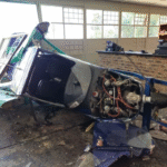 SACAA Concludes Fuel Miscalculation Led To Training Aircraft Crash Into Gauteng School SEO DES: The pilot-in-command, a flight instructor at Accolade Flying Wings Academy breached CAR 91.07.12 by failing to ensure sufficient usable fuel & required reserves SOCIAL: The South African Civil Aviation Authority has determined that fuel exhaustion caused a training aircraft of Accolade Flying Wings Academy to crash into a school building in Alberton, Gauteng, on 26 October 2025. According to the final report by the Accident and Incident Investigations Division (AIID), the Tecnam P92 Echo (ZU-BJX) was returning to Rand Aerodrome after a multi-leg cross-country training flight when its engine stopped at about 6,500 ft. The instructor attempted restarts before conducting a forced landing on a sports field at Hoërskool Alberton, but the aircraft overran the 120-metre field and struck the school cafeteria. No injuries were reported, though the aircraft was destroyed. Investigators found both fuel tanks dry and no mechanical faults. The report concluded the engine failed due to fuel exhaustion, citing fuel mismanagement and inadequate pre-flight planning, and noted non-compliance with fuel reserve regulations. Alberton, South Africa: The South African Civil Aviation Authority has concluded that fuel exhaustion caused the crash of a training aircraft into a school building in Gauteng last year. The accident occurred on 26 October 2025 when a Tecnam P92 Echo, registration ZU-BJX of Accolade Flying Wings Academy operating under Part 141 training regulations suffered an engine stoppage while returning to Rand Aerodrome. The aircraft was being flown by a 30-year-old commercial pilot acting as flight instructor, accompanied by a student pilot, on a cross-country navigational training exercise. According to the Accident and Incident Investigations Division (AIID) report the flight departed Rand at approximately 0800 UTC after filing a flight plan with Johannesburg briefing. The planned routing included stops at Vereeniging Aerodrome, Potchefstroom Aerodrome, Rustenburg Aerodrome and Carletonville Aerodrome before returning to Rand. Investigators said the aircraft had been refuelled to 70 litres of Avgas 100LL prior to departure. The crew calculated this would provide approximately three and a half hours of endurance. The Tecnam P92 Echo is equipped with two wing tanks with a total usable fuel capacity of 66.8 litres, with 3.2 litres considered unusable. At approximately 6,500 feet above ground level, while overhead the Alberton residential area and after being cleared to join the circuit for Runway 35 at Rand, the engine stopped. The instructor took control and attempted several restarts, but the engine did not respond. He then identified a sports field at Hoërskool Alberton as a forced landing site. The aircraft touched down in the middle of the field but was unable to stop within the available distance of approximately 120 metres. The P92 Echo requires roughly 300 metres for landing rollout. The aircraft overran the field and impacted the school cafeteria building, coming to rest halfway inside the structure. Neither occupant was injured, and no injuries were reported on the ground. However, the aircraft was destroyed and the school building sustained structural damage. The AIID’s post-accident examination found no mechanical defects. Investigators reported no fuel leakage at the site. Both fuel tanks were dry, the gascolator contained no fuel, and only approximately three litres of unusable fuel were drained from the system. The engine was later test-run and operated normally, meeting all maintenance manual parameters. Based on fuel burn calculations, investigators determined that the aircraft consumed an estimated 59.5 litres during the flight, including fuel used during a touch-and-go landing. Approximately 4.5 litres could not be reconciled but may have been consumed during ground running prior to departure. The report concluded that the engine stopped due to fuel exhaustion. The investigation further found that the pilot-in-command did not comply with Part 91.07.12 of the Civil Aviation Regulations (CAR) 2011, which requires pilots to ensure sufficient usable fuel is carried to complete a flight safely and to maintain required reserves. In its findings, the authority cited fuel mismanagement and inadequate pre-flight planning as contributing factors. The report emphasised the importance of cross-checking fuel quantity using at least two independent methods and adopting conservative planning margins. The limited investigation was conducted in accordance with Regulation 12.03.1 of the CAR 2011 and ICAO Annex 13. The AIID stated that the purpose of the report is to promote aviation safety and reduce the risk of similar occurrences, not to apportion blame or liability. Recent Flight Training School Incidents in South Africa: 19 February, 2026: A light-aircraft training flight crashed killing both the flight instructor and the student pilot on board. The aircraft was operated by Excellentia Airline Academy, and the two occupants aged 28 and 24 were pronounced dead at the scene after the plane went down shortly before 6 p.m. Rescue teams, including Aeronautical Rescue Coordination Centre units and police, responded immediately. A full investigation by the South African Civil Aviation Authority is underway to determine the cause of the crash 04 February, 2026: A Piper Cherokee 140 (ZS‑XPR) training aircraft departing from Grand Central Airport crashed near Carstenhof Hospital in Glen Austin, Midrand during a training flight. Both the flight instructor and the student pilot on board suffered serious injuries and were rushed to hospital, and the aircraft was substantially damaged. 26 October, 2025: During a morning training flight, a light aircraft suffered engine failure and attempted an emergency landing in a school field, veering into a tuckshop of Hoërskool Alberton in the City of Ekurhuleni, Gauteng. Both the instructor and student escaped unharmed. 15 October, 2025: Two training aircraft from Aviation Junction Flying School in Secunda, Mpumalanga, took off on routine flights over the KwaZulu‑Natal Midlands. Both aircraft Sling 2 types encountered poor weather with heavy mist and low visibility, lost contact with radio and radar, and later crashed in separate locations near Nottingham Road and Pietermaritzburg. The 26‑year‑old Indian trainee pilot Mayank Prajapati and 35‑year‑old South African pilot Martin Brown were killed in the twin crashes, prompting intensified calls for safety reforms in South Africa’s flight‑training sector. 13 October, 2025: A tragic training accident claimed the life of 20‑year‑old Piyush Pushp, a student from Ranchi, India, while he was undergoing solo flight training at the Vulcan Aviation Institute in Johannesburg. During the solo sortie, the light training aircraft reportedly suffered a sudden technical malfunction mid‑air, leading to a crash shortly after take‑off. 10 June, 2025: The aircraft, operated by Eagle Air Flight School, was part of a trio of light planes flying in a loose formation from an airstrip near Durban toward Pretoria. The group encountered severe weather, including low visibility and turbulence, which led them to divert from their planned refuelling stop in Ladysmith toward Greytown & crashed. Airport emergency responders arrived but all three pilots were killed.