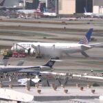 United Airlines Boeing 787 Makes Emergency Return To LAX After Engine Fire Report SEO DES: Emergency crews responded as smoke was reported from one engine and passengers evacuated using slides and mobile stairs, No serious injuries were reported SOCIAL: An United Airlines Boeing 787-9 operating Flight UA2127 from Los Angeles to Newark returned to Los Angeles International Airport shortly after takeoff on Monday after the crew reported an engine fire. The aircraft, carrying 256 passengers and 12 crew members, declared an emergency and landed safely at 11:19 a.m. Emergency crews responded as smoke was reported from one engine, and passengers evacuated using slides and mobile stairs. No serious injuries were reported. The FAA briefly issued a ground stop at LAX and has launched an investigation into the incident. Image: ABC7 Video: Fox News Los Angeles, United States: An United Airlines Boeing 787-9 Dreamliner bound for New Jersey was forced to make an emergency return to Los Angeles International Airport (LAX) on Monday after its crew reported an engine fire shortly after takeoff, authorities and airline officials said. United Flight UA2127 departed LAX at approximately 10:43 a.m. local time for Newark Liberty International Airport (EWR) with 256 passengers and 12 crew members aboard. Moments after departure, the flight crew reported trouble with the aircraft’s left-hand engine and declared an emergency with air traffic control. The Boeing 787-9, a twin-engine wide-body long-haul aircraft, began its return to LAX shortly before 11:00 a.m. and landed safely at 11:19 a.m. local time, according to Federal Aviation Administration (FAA) advisories and flight tracking data. As the aircraft approached its runway, emergency responders on the ground were alerted to reports of smoke or fire from one engine. Local fire crews, including the Los Angeles Fire Department, responded to contain the situation after landing. Video posted on social media showed plumes of dark smoke emanating from the affected engine on final approach. Once on the ground, the cabin crew initiated an evacuation. Passengers exited via inflatable emergency slides and mobile stairs onto a taxiway off the runway, then were transported by buses to the terminal. Emergency services remained on site to monitor and extinguish any remaining flame or heat from the engine. United Airlines confirmed in a statement that there were no serious injuries reported among passengers and crew. The FAA temporarily halted inbound flights to LAX for about 30 to 90 minutes following the incident, issuing a ground stop as emergency crews assisted on the scene. The ground stop was later lifted, though some incoming flights faced delays of up to 30 minutes. The FAA has opened an investigation to determine the precise cause of the engine malfunction and the subsequent fire reports. At this time, no official cause has been confirmed by the airline or regulators. Federal authorities typically examine flight data, engine health parameters, and cockpit voice recordings in such incidents.