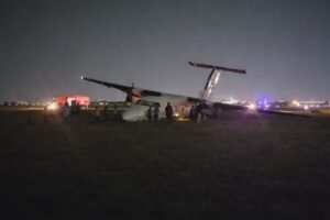 Safarilink Aircraft Veers Off Runway At Wilson Airport, All 39 Onboard Escape Unharmed SEO DES: Wet runway & low visibility caused loss of directional control during rollout, Aircraft sustained nose, landing gear & propeller damage; AAID probe underway SOCIAL: A Safarilink Aviation aircraft veered off the runway while landing at Wilson Airport on Friday night, carrying 39 people, including 34 passengers and five crew. All occupants escaped unharmed. The Flight 090 aircraft from Kisumu to Nairobi reportedly skidded off a wet runway and came to rest on a grassy area. The Kenya Airports Authority confirmed there were no injuries. The aircraft sustained damage to its nose, landing gear, and propeller. Adverse weather conditions are suspected as a contributing factor, while Kenya’s Aircraft Accident Investigation Department has launched a probe. Image: FL360aero Video: FL360aero Nairobi, Kenya: A Safarilink Aviation passenger aircraft veered off the runway while landing at Wilson Airport on Friday night, triggering fresh scrutiny over safety, infrastructure, and emergency preparedness at one of East Africa’s busiest domestic aviation hubs. The aircraft, operating as Flight 090 from Kisumu to Nairobi, was carrying 39 people onboard, including 34 passengers and five crew members, when the incident occurred at approximately 8:55 PM (2055 hrs). All occupants escaped without injury, authorities confirmed. According to airline and airport statements, the aircraft, a De Havilland DHC-8-100 (Dash 8) operated by ALS Limited on behalf of Safarilink skidded off the runway during landing and came to a stop on a grassy section near a runway intersection. The Kenya Airports Authority (KAA) confirmed the runway excursion in an official statement, “An aircraft with thirty nine passengers on board… veered off the runway, all passengers and crew are safe, with no injuries reported.” The aircraft sustained visible damage, including to its nose section, landing gear, and propeller, though no fire or fatalities occurred. Initial details point to adverse runway conditions as a contributing factor. The runway was reported to be wet due to rain, with reduced visibility at the time of landing The aircraft lost directional control during rollout, leading to the excursion Passengers described a sudden and forceful deviation from the runway, turning what should have been a routine landing into a high-risk situation. Among those onboard was Vihiga Senator Godfrey Osotsi, who described the incident as a “crash-landing” and credited the flight crew for preventing a catastrophe. “I commend the pilot… for controlling the aircraft and steering it off the runway, causing it to stall an action that averted what could have been a catastrophic fire,” he said. The manoeuvre likely prevented the aircraft from continuing at speed along the runway, reducing the risk of fire or structural breakup. Osotsi, speaking as a survivor, said all onboard escaped safely but highlighted the severity of the situation: “I came out safely from an aircraft accident… I was among the 39 passengers on board.” Passengers experienced a sudden loss of control during landing, followed by an abrupt stop after the aircraft exited the runway. No serious injuries were reported, and all occupants were safely evacuated. Despite the safe outcome, the incident has sparked serious concerns over airport safety systems. Osotsi alleged critical failures in emergency response, stating: No ambulance was present No immediate rescue or emergency team responded Passengers were initially left without assistance “There was no ambulance on site and no emergency response team came to our aid,” he said. Kenya’s Aircraft Accident Investigation Department (AAID) has launched a formal probe into the incident.