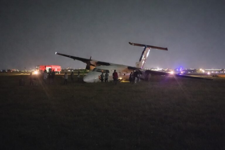 Safarilink Aircraft Veers Off Runway At Wilson Airport, All 39 Onboard Escape Unharmed SEO DES: Wet runway & low visibility caused loss of directional control during rollout, Aircraft sustained nose, landing gear & propeller damage; AAID probe underway SOCIAL: A Safarilink Aviation aircraft veered off the runway while landing at Wilson Airport on Friday night, carrying 39 people, including 34 passengers and five crew. All occupants escaped unharmed. The Flight 090 aircraft from Kisumu to Nairobi reportedly skidded off a wet runway and came to rest on a grassy area. The Kenya Airports Authority confirmed there were no injuries. The aircraft sustained damage to its nose, landing gear, and propeller. Adverse weather conditions are suspected as a contributing factor, while Kenya’s Aircraft Accident Investigation Department has launched a probe. Image: FL360aero Video: FL360aero Nairobi, Kenya: A Safarilink Aviation passenger aircraft veered off the runway while landing at Wilson Airport on Friday night, triggering fresh scrutiny over safety, infrastructure, and emergency preparedness at one of East Africa’s busiest domestic aviation hubs. The aircraft, operating as Flight 090 from Kisumu to Nairobi, was carrying 39 people onboard, including 34 passengers and five crew members, when the incident occurred at approximately 8:55 PM (2055 hrs). All occupants escaped without injury, authorities confirmed. According to airline and airport statements, the aircraft, a De Havilland DHC-8-100 (Dash 8) operated by ALS Limited on behalf of Safarilink skidded off the runway during landing and came to a stop on a grassy section near a runway intersection. The Kenya Airports Authority (KAA) confirmed the runway excursion in an official statement, “An aircraft with thirty nine passengers on board… veered off the runway, all passengers and crew are safe, with no injuries reported.” The aircraft sustained visible damage, including to its nose section, landing gear, and propeller, though no fire or fatalities occurred. Initial details point to adverse runway conditions as a contributing factor. The runway was reported to be wet due to rain, with reduced visibility at the time of landing The aircraft lost directional control during rollout, leading to the excursion Passengers described a sudden and forceful deviation from the runway, turning what should have been a routine landing into a high-risk situation. Among those onboard was Vihiga Senator Godfrey Osotsi, who described the incident as a “crash-landing” and credited the flight crew for preventing a catastrophe. “I commend the pilot… for controlling the aircraft and steering it off the runway, causing it to stall an action that averted what could have been a catastrophic fire,” he said. The manoeuvre likely prevented the aircraft from continuing at speed along the runway, reducing the risk of fire or structural breakup. Osotsi, speaking as a survivor, said all onboard escaped safely but highlighted the severity of the situation: “I came out safely from an aircraft accident… I was among the 39 passengers on board.” Passengers experienced a sudden loss of control during landing, followed by an abrupt stop after the aircraft exited the runway. No serious injuries were reported, and all occupants were safely evacuated. Despite the safe outcome, the incident has sparked serious concerns over airport safety systems. Osotsi alleged critical failures in emergency response, stating: No ambulance was present No immediate rescue or emergency team responded Passengers were initially left without assistance “There was no ambulance on site and no emergency response team came to our aid,” he said. Kenya’s Aircraft Accident Investigation Department (AAID) has launched a formal probe into the incident.