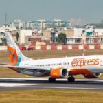 Air India Express Flight Makes Emergency Landing In Lucknow After Mid-Air Smoke Alert SEO DES: Oxygen masks were deployed inside the cabin, leading to panic among passengers. The aircraft carrying 148 people diverted safely with no injuries SOCIAL: A Delhi-bound Air India Express flight (IX 1523) made an emergency landing in Lucknow after a Mayday call over suspected onboard smoke. The aircraft, carrying 148 people, diverted safely with no injuries. Oxygen masks were deployed mid-air, causing panic, while authorities activated full emergency response on ground. Post-landing checks found no visible smoke or fire; the aircraft had been grounded for detailed inspection, and passengers were provided alternate arrangements. Lucknow, India: A Delhi-bound Air India Express flight made an emergency landing at Chaudhary Charan Singh International Airport on Monday evening after the crew issued a Mayday call following suspected smoke inside the aircraft, triggering a full-scale emergency response. Flight IX 1523, operating from Bagdogra to Delhi, declared the distress call at around 4:58 pm while cruising at approximately 36,000 feet over Uttar Pradesh’s Ambedkar Nagar region. There were 148 passengers and crew onboard. The cockpit reportedly received indications of possible smoke from onboard systems, prompting immediate emergency procedures. As a precautionary measure, oxygen masks were deployed inside the cabin, leading to panic among passengers. Crew members managed the situation while coordinating with air traffic control for a diversion. Following the Mayday alert, authorities at Lucknow airport declared a full emergency, with fire tenders, medical teams, and rescue personnel placed on standby ahead of the aircraft’s arrival. The flight was diverted and landed safely at the airport, where emergency protocols were executed in line with standard aviation safety procedures. All passengers and crew onboard were safely evacuated, and no injuries were reported. Initial inspections conducted after landing did not detect any visible smoke or fire despite the earlier cockpit indications. The aircraft has since been grounded as a precaution and will undergo detailed technical checks before being cleared for further operations, according to reports. Passengers experienced delays and uncertainty regarding onward travel, with arrangements being made for alternate flights and assistance as required.