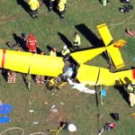 Berrima, Australia: A pilot suffered critical injuries after a light aircraft crashed into a paddock in the Southern Highlands region of New South Wales on Thursday morning, triggering a large-scale emergency response and an ongoing investigation into the cause of the accident. Emergency services were called to Medway Road in Berrima at approximately 7:45–7:50 am on April 16, 2026, following reports that a small aircraft had gone down in an open field. Responding crews, including police, Fire and Rescue NSW, NSW Ambulance, the State Emergency Service (SES), and the Rural Fire Service, arrived to find a severely damaged recreational plane with its sole occupant trapped inside the wreckage. The aircraft has been identified as a Hornet STOL ultralight, a small fixed-wing aluminium recreational plane. Initial information indicates the aircraft came down under unknown circumstances, with no immediate indication of the cause. The pilot, a man believed to be in his 50s, was trapped inside the wreckage “for some time” before firefighters were able to extricate him in a complex rescue operation. Paramedics treated the man at the scene for significant face and leg injuries before he was airlifted by helicopter to Liverpool Hospital. Authorities confirmed he remains in critical condition. The crash prompted a substantial multi-agency emergency deployment. Fire and Rescue NSW dispatched at least five units, including specialised HAZMAT crews, who worked to isolate a minor fuel leak and mitigate the risk of fire at the crash site. NSW Ambulance deployed multiple crews along with two helicopters, while police and other emergency services secured the area and assisted in the rescue effort. Aerial footage from the scene showed the aircraft described as a yellow plane with red markings lying heavily damaged in a paddock as emergency personnel worked around the wreckage. New South Wales Police have launched an investigation into the incident, and aviation authorities have been notified. The Australian Transport Safety Bureau (ATSB) confirmed it is aware of the crash, although it typically investigates recreational aircraft incidents only in exceptional circumstances. At this stage, the circumstances leading up to the crash remain unclear, and no further details have been released regarding the flight’s origin, intended destination, or weather conditions at the time of the incident.