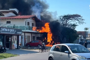 Capão da Canoa, Brazil: A light aircraft crashed into a restaurant in southern Brazil’s coastal town of Capão da Canoa on Friday morning, killing all four people on board and triggering a large explosion that sent flames and thick smoke billowing into the surrounding residential area. The aircraft, identified as a Piper Malibu (PA-46 series), went down at approximately 10:30 a.m. local time shortly after departing from Capão da Canoa Airport. It was reportedly en route to São Paulo when it lost altitude during a critical phase of flight. Authorities said the aircraft was owned by Jetspeed Holding Ltda and was carrying four occupants. Preliminary information suggests the aircraft was flying at a low altitude and appeared unstable moments before the crash. Witnesses reported seeing the plane descend rapidly before it struck a pole near the runway and veered into the Dom Inácio restaurant. The impact triggered a powerful fireball, with video footage from the scene showing pedestrians running for safety seconds before the aircraft slammed into the structure. All four occupants on board were killed in the crash. Officials confirmed the victims included two pilots and two passengers, believed to be a couple traveling for business. Despite the intensity of the crash, no fatalities were reported on the ground. Authorities said the restaurant and an adjacent commercial establishment were closed at the time of the accident, likely preventing a higher casualty count. Eyewitnesses described the aircraft as flying unusually low before impact, with several people in the vicinity narrowly escaping the crash site. Emergency services, including firefighters, Civil Defense teams, and military police, responded swiftly to the scene. The surrounding area was evacuated as a precaution while crews worked to contain the fire and secure the wreckage. Forensic teams were deployed to recover remains and begin examination of the crash site. Rio Grande do Sul Governor Eduardo Leite confirmed the incident and said emergency teams had brought the situation under control. He stated that the crash site was secured and that authorities were working to support the victims’ families while coordinating the investigation. Brazilian aviation authorities have launched an inquiry into the cause of the crash. Investigators are examining the possibility of an obstacle strike, loss of control, or mechanical failure, and are reviewing eyewitness accounts, aircraft maintenance records, and operational conditions at the time of the accident. The exact cause remains undetermined.